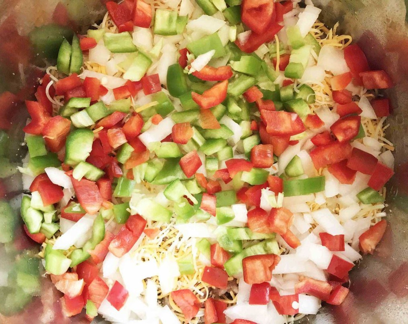 step 8 Repeat the layers with the remaining hash browns, cheddar cheese (1 cup), Monterey jack cheese (1/4 cup), onion, red bell pepper, and green bell pepper.