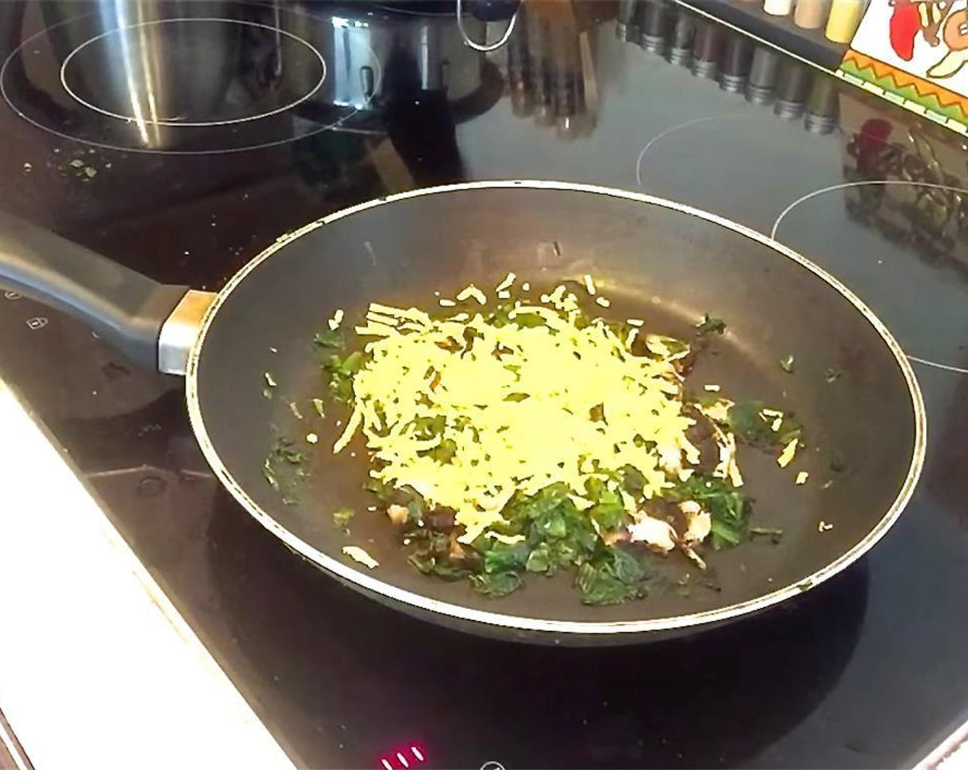 step 1 Chop the Portobello Mushroom (1) and saute it with the Frozen Spinach (to taste) in a pan on the stovetop until spinach is cooked. Add Vegan Cheddar Cheese (to taste) to the top. Heat until melted.