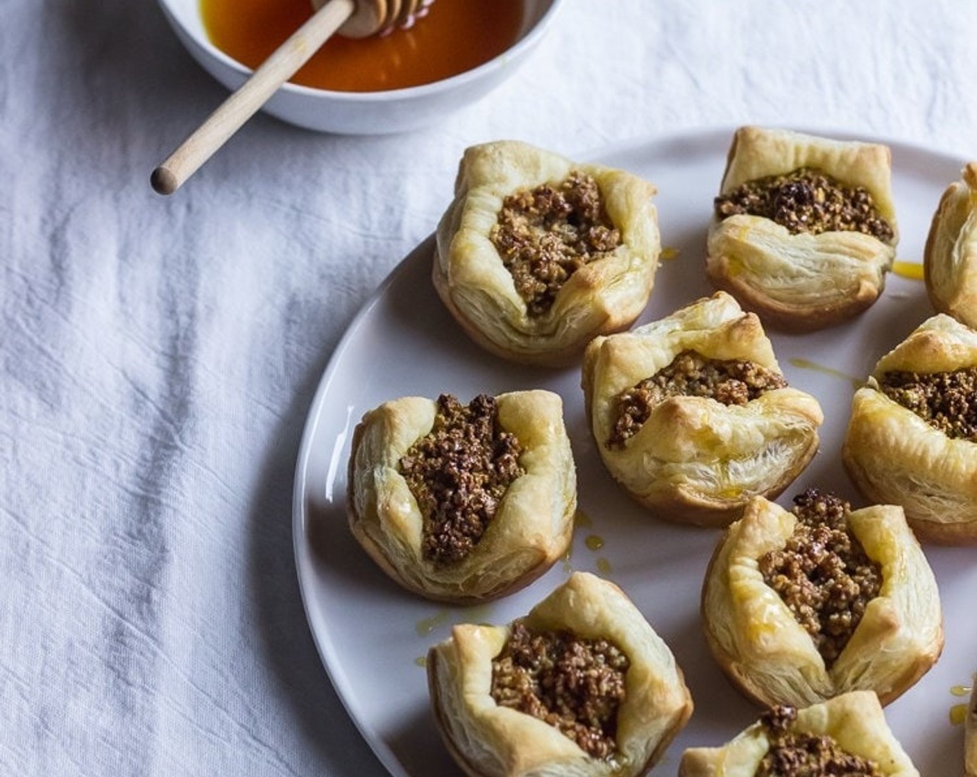 step 8 Drizzle 1 tablespoon of honey syrup over each piece of baklava while still hot & then serve. Enjoy!