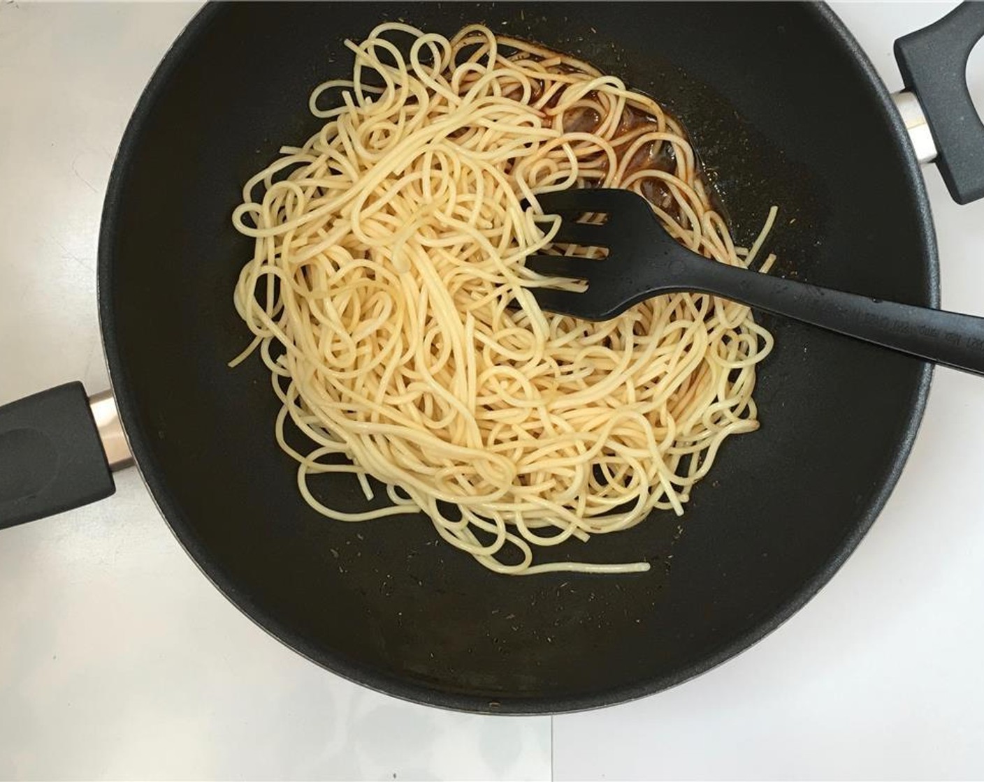 step 7 Place the wok over medium heat. Once the oil is warm and the tomato paste starts to fry, add 1/3 cup (80 mL) of water (or pasta cooking liquid). Stir and let this mixture reduce by half. Then add the cooked pasta.