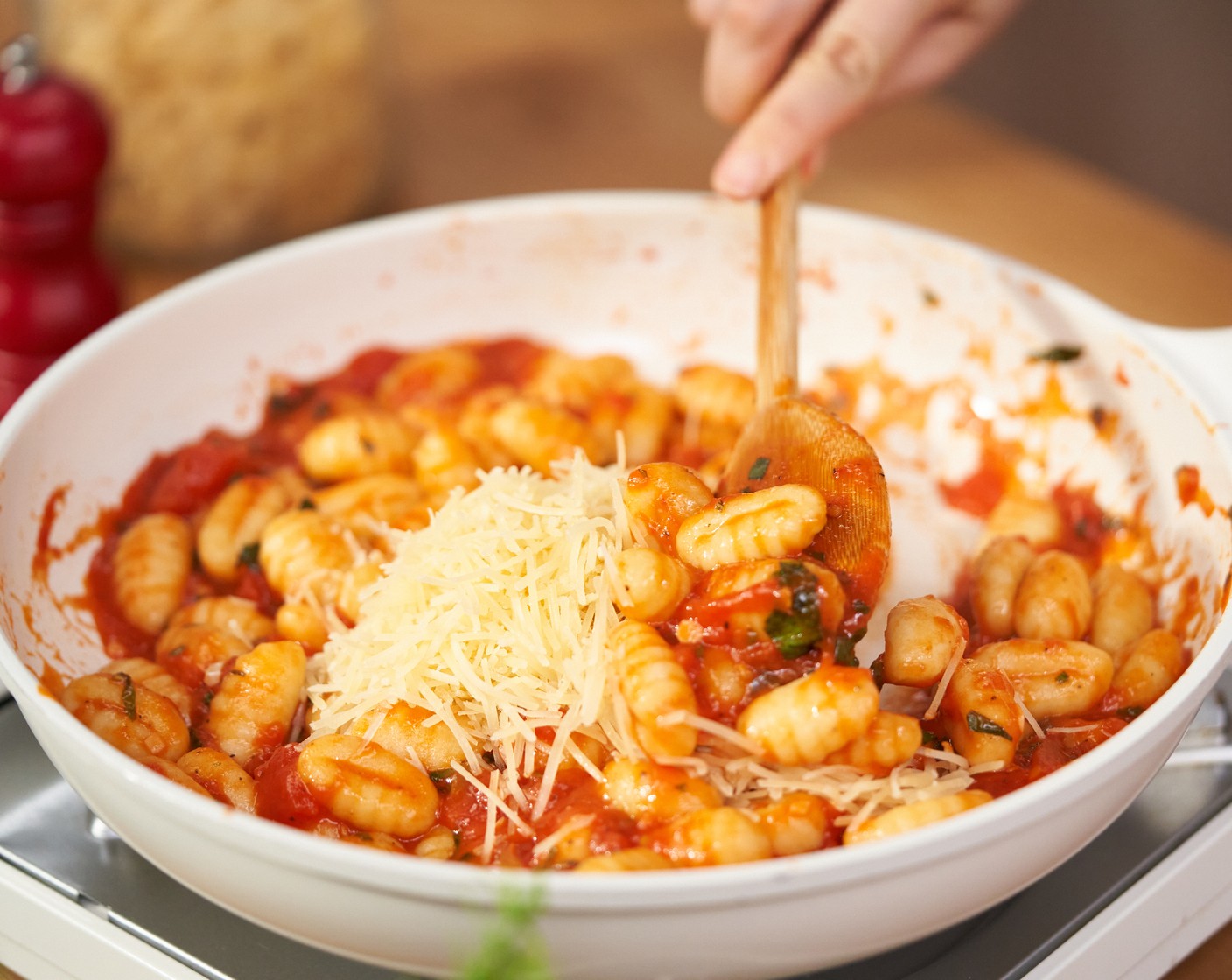 step 5 Use a slotted spoon to transfer gnocchi to the sauce. Add Grated Parmesan Cheese (1/2 cup). Gently toss the gnocchi in the sauce.