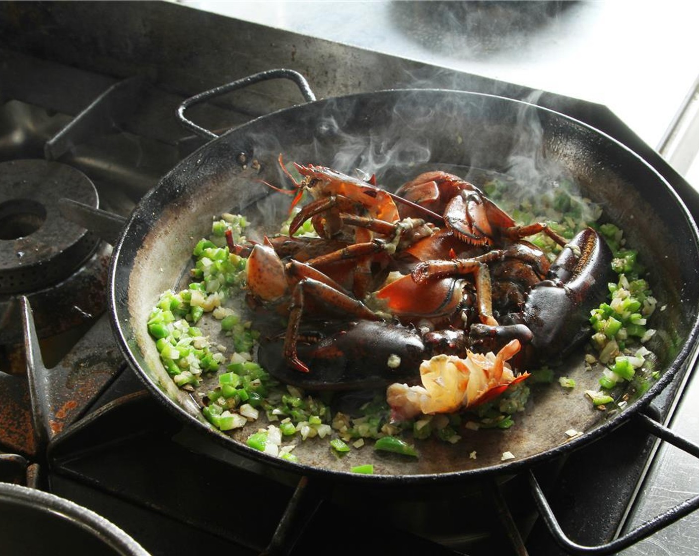 step 11 Add the lobster and cook it until the juices are released. Once the lobster is nicely seared. Remove the pieces from the pan, but keep the head.