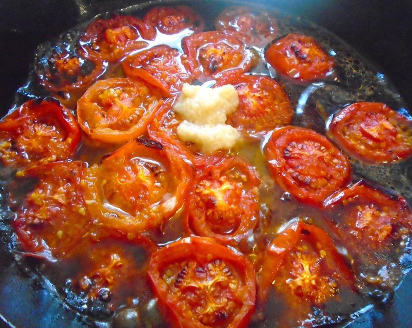 step 5 Return the pan to the stove. Add Water (2 cups) and Garlic Paste (1 tsp), and simmer until tomatoes have broken down and a sauce has developed for about 20 minutes.