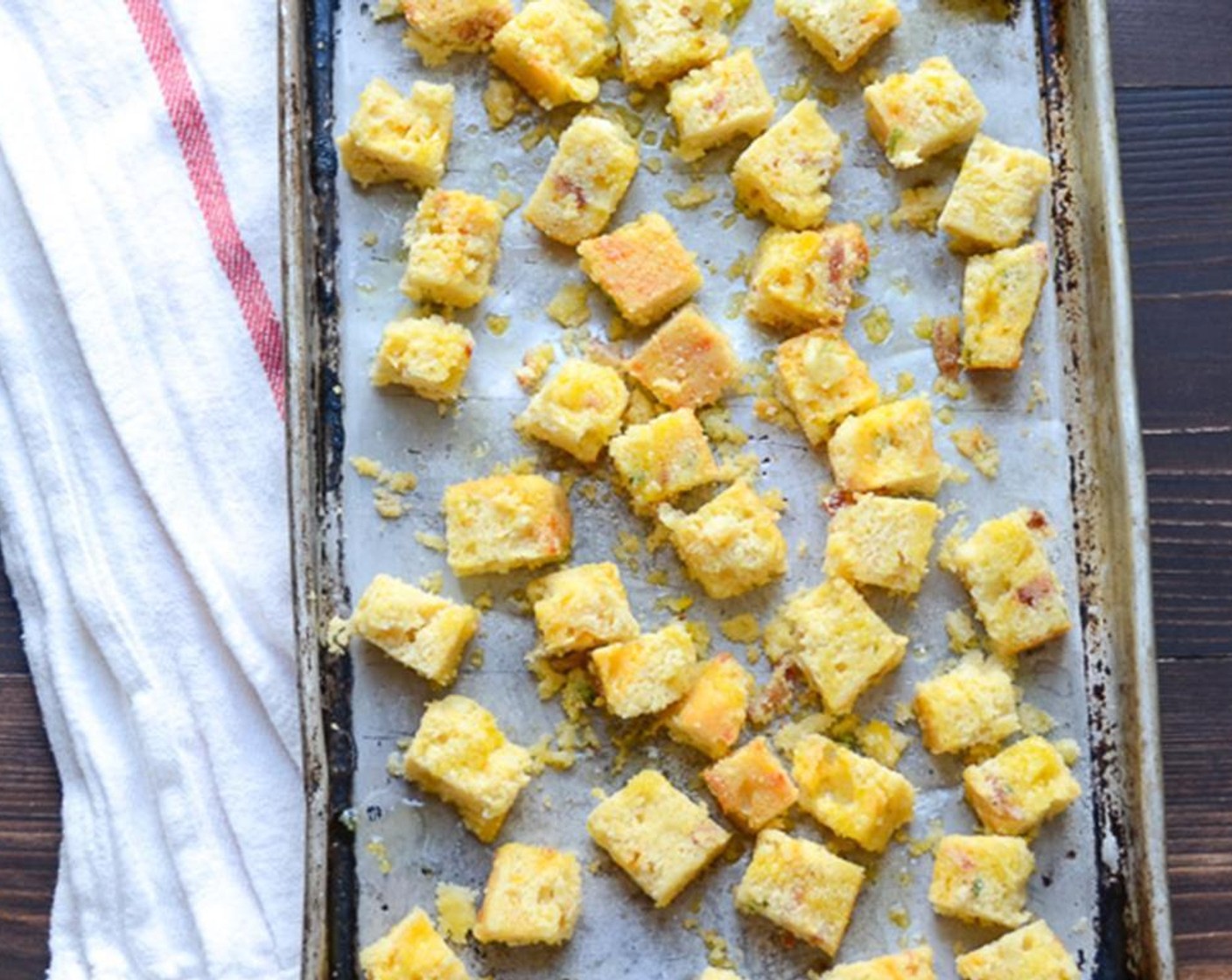 step 5 Cut the Cornbread (300 g) into half-inch pieces. Place the cornbread on a cookie sheet and drizzle with the Olive Oil (2 Tbsp). Using your hands, toss the cornbread to coat with the olive oil. Bake for 7 to 8 minutes.