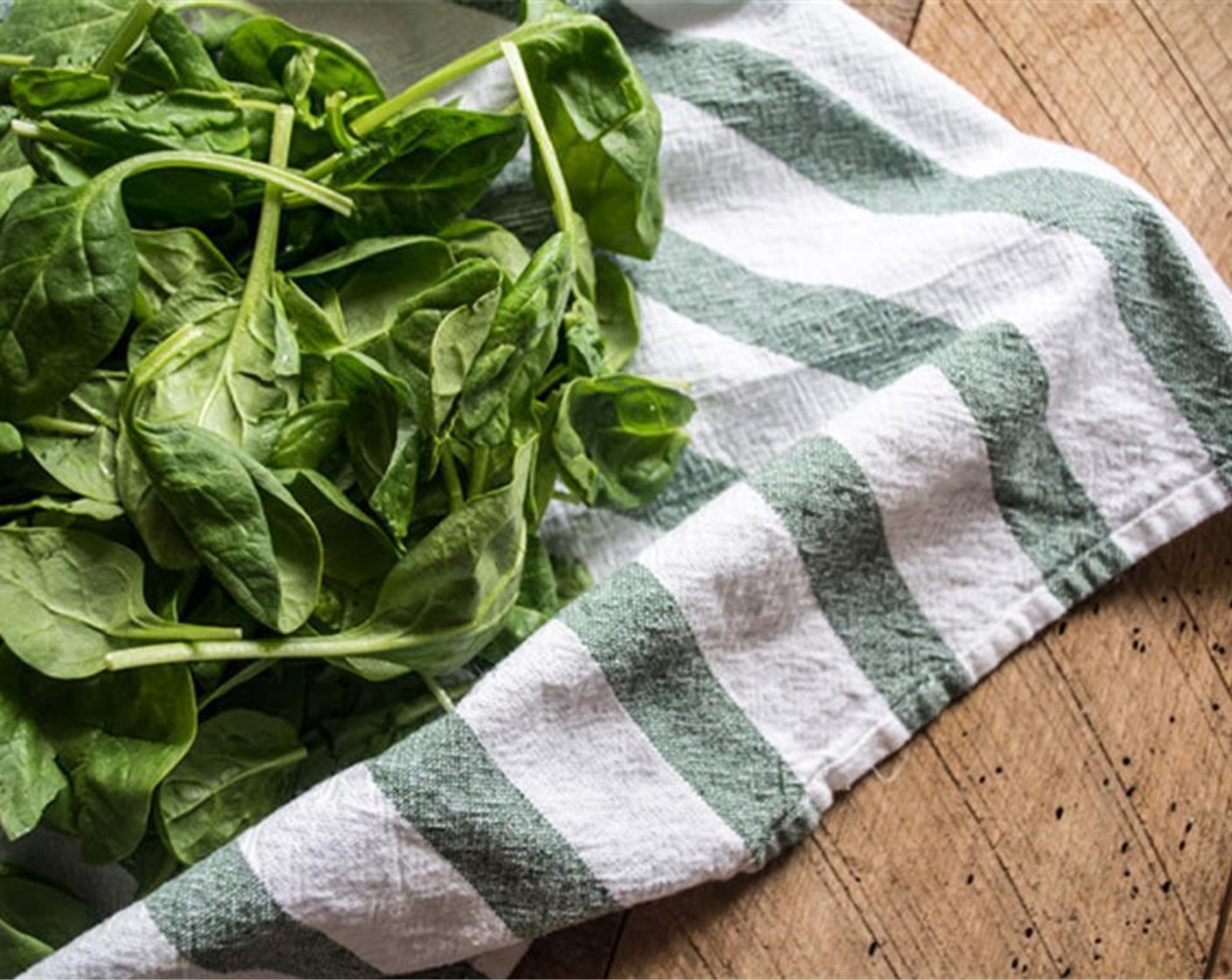 step 9 For the spinach filling, add Coconut Oil (1/2 Tbsp) to medium saucepan, once oil is hot, add in Fresh Spinach (4 cups) and cook until leaves are wilted, stirring frequently. Remove cooked spinach from heat and set aside to cool.