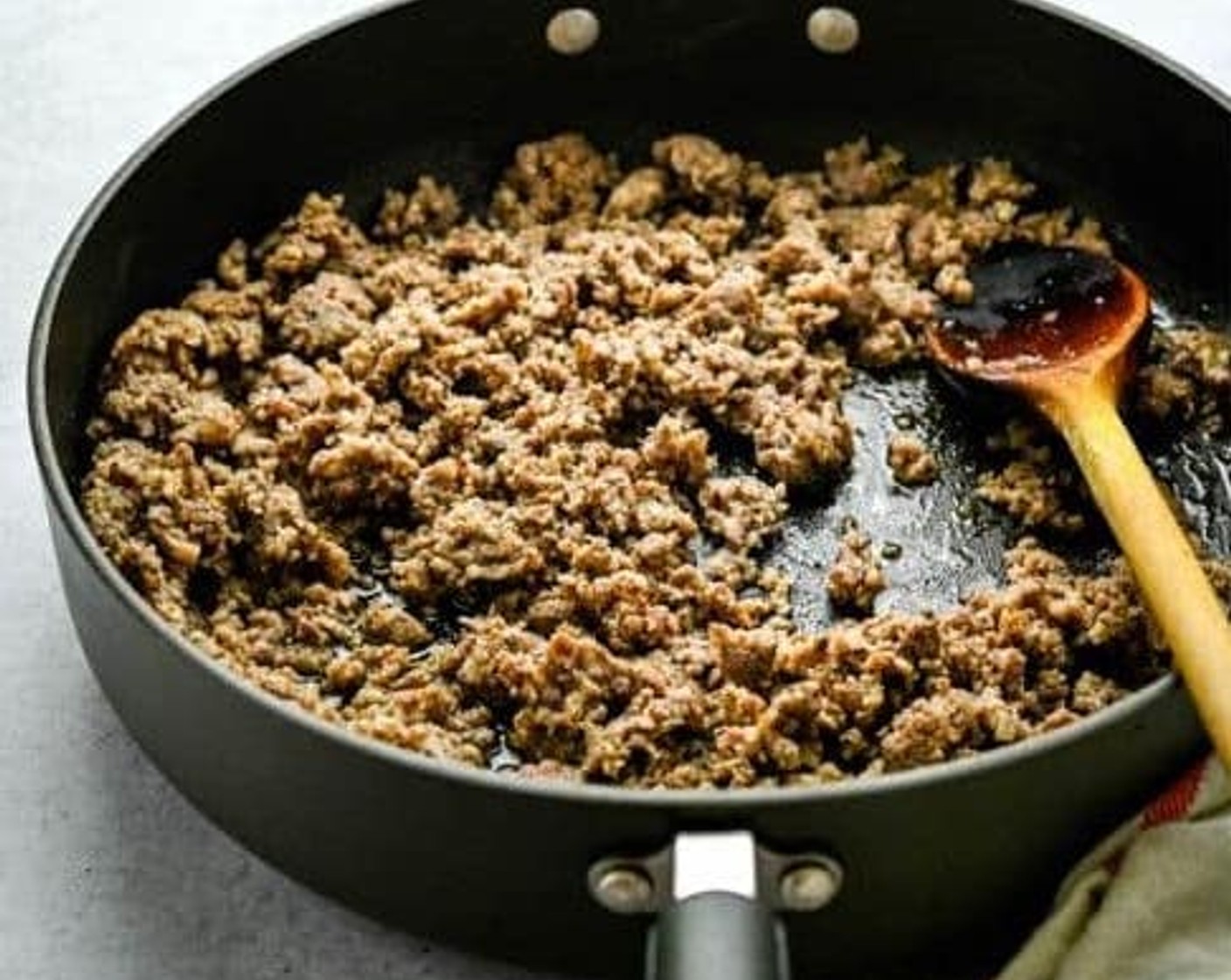 step 4 In a large skillet over medium high heat, add the Spicy Italian Ground Sausage (1 lb) and break apart with the back of a wooden spoon. Cook until browned.