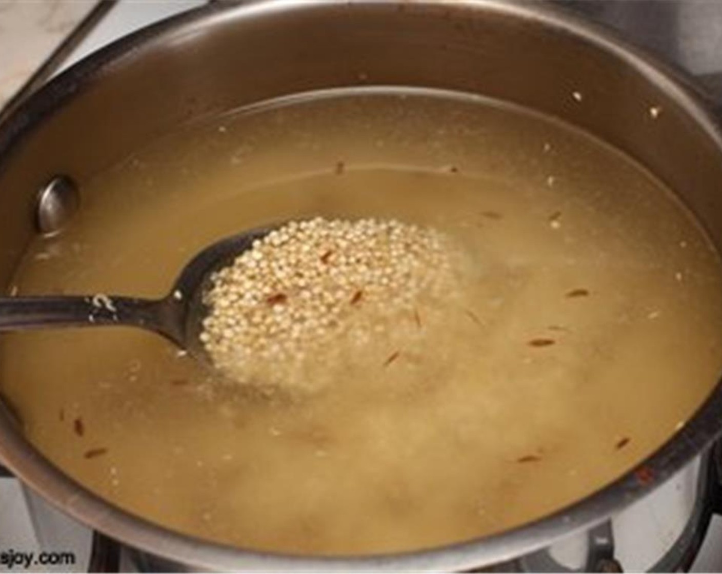 step 5 While the tofu bakes, heat Olive Oil (1 tsp) in a medium saucepan and add Cumin Seeds (1/4 tsp). Add Quinoa (1 1/4 cups) and Water (2 1/2 cups).