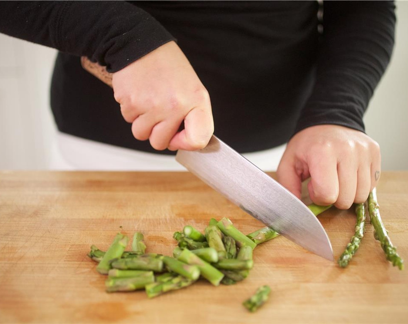 step 1 Trim Asparagus (3/4 cup) by snapping the thicker bottom ends where they break naturally, and discard bottoms ends. Cut into one inch pieces on the bias, and set aside.