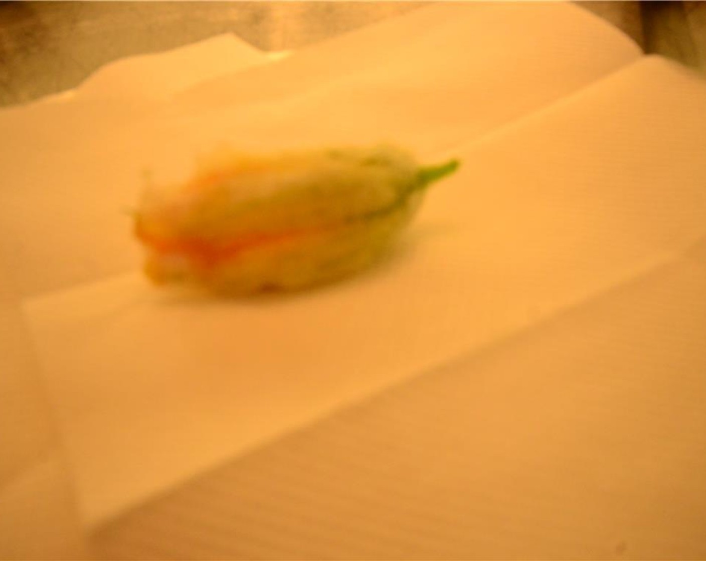 step 12 Place the fried tempura blossom on a paper towel-lined plate. Let cool before plating.