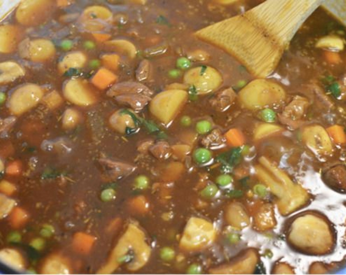 step 13 Once the stew has reached the consistency you like, turn the heat off, add the Frozen Peas and Carrots (1 1/2 cups), and Fresh Parsley (1 handful).