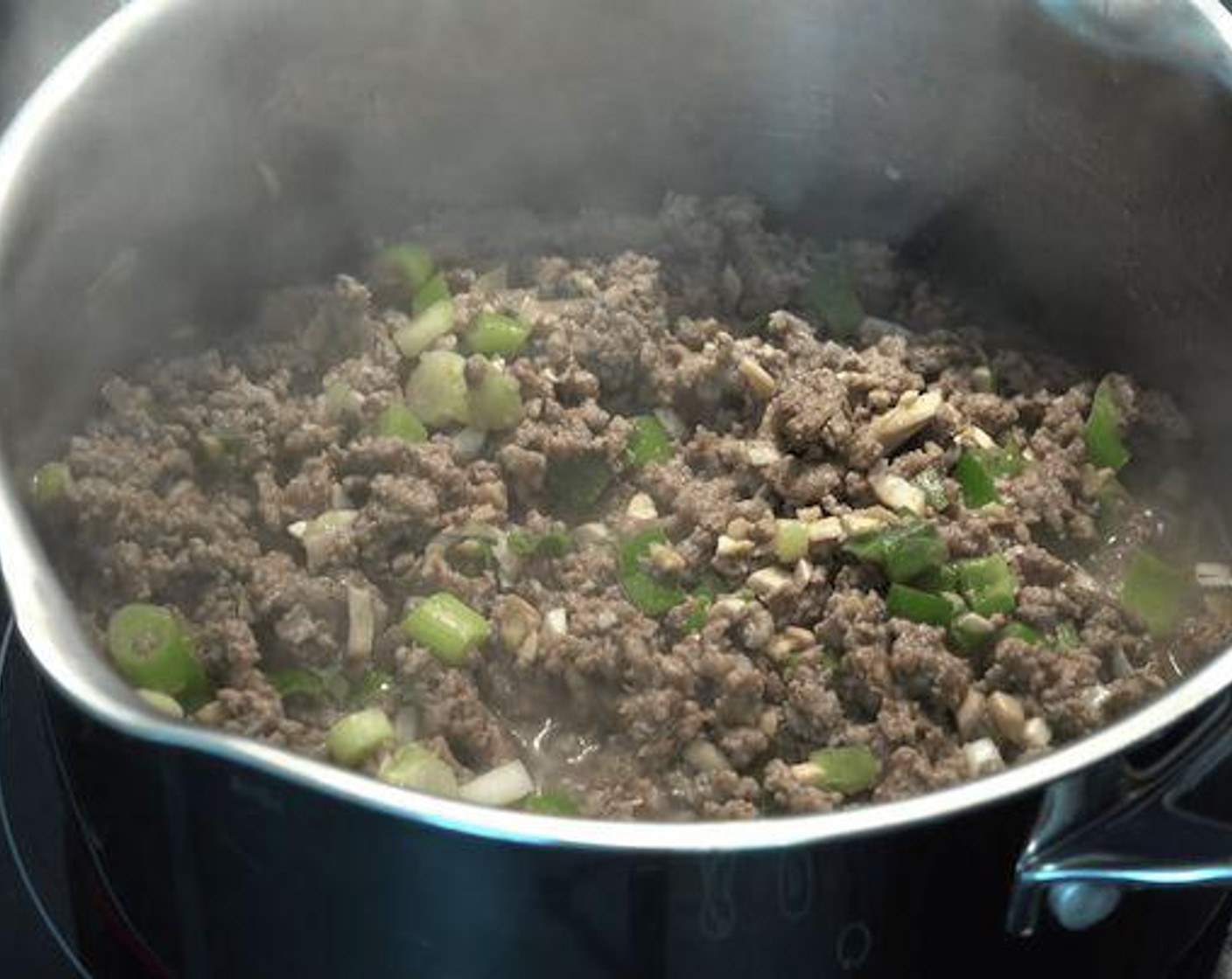 step 3 While beef is cooking add in the Scallion (1 bunch) and Button Mushrooms (6) and stir. Add in Salt (to taste), Ground Black Pepper (to taste), Dried Thyme (1/2 Tbsp) and Worcestershire Sauce (1 Tbsp) then continue to stir.