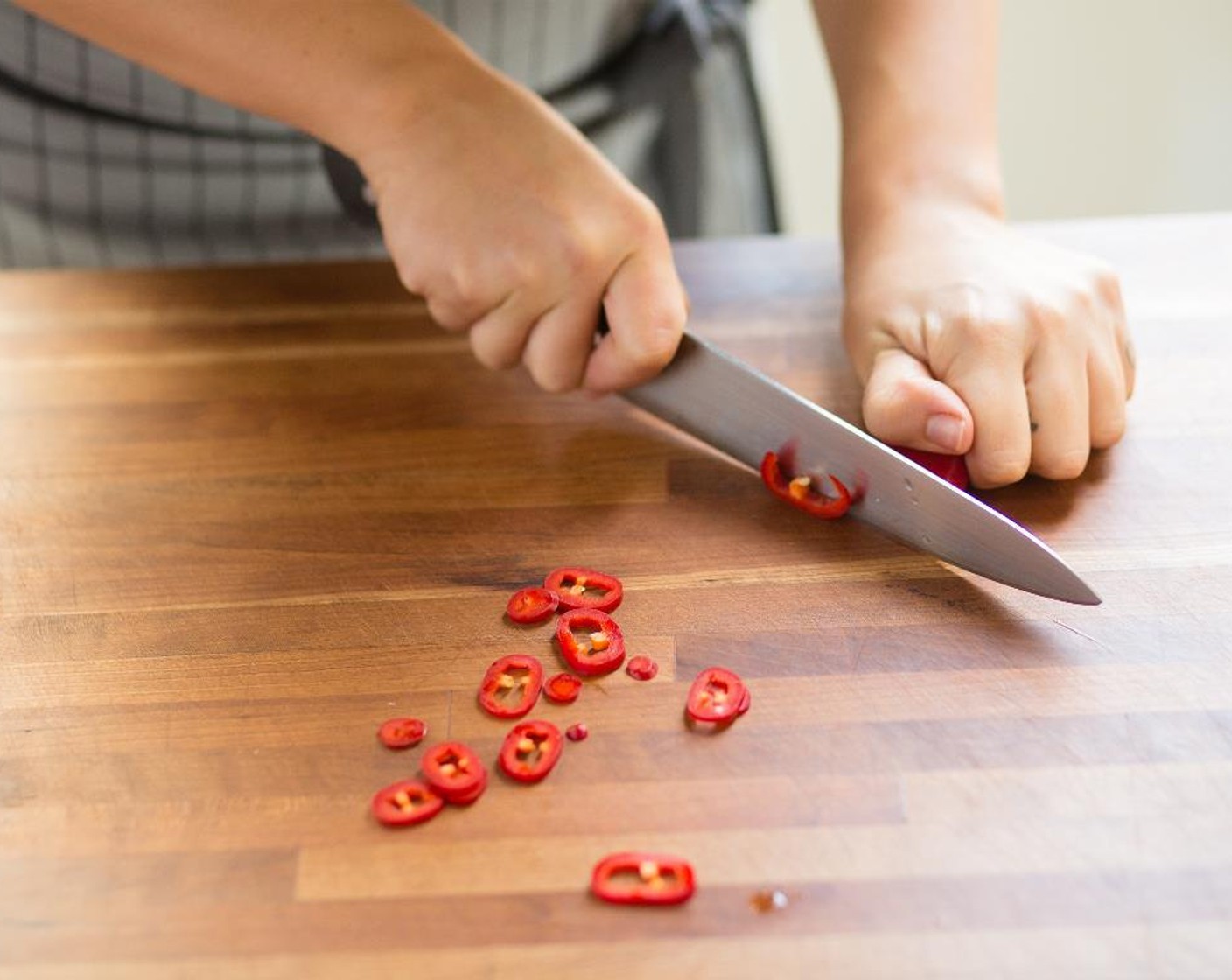 step 2 Remove the stem, pith and seeds from the Red Fresno Chili Pepper (1) and discard. Slice the chili into 1/4 inch rounds and set aside.