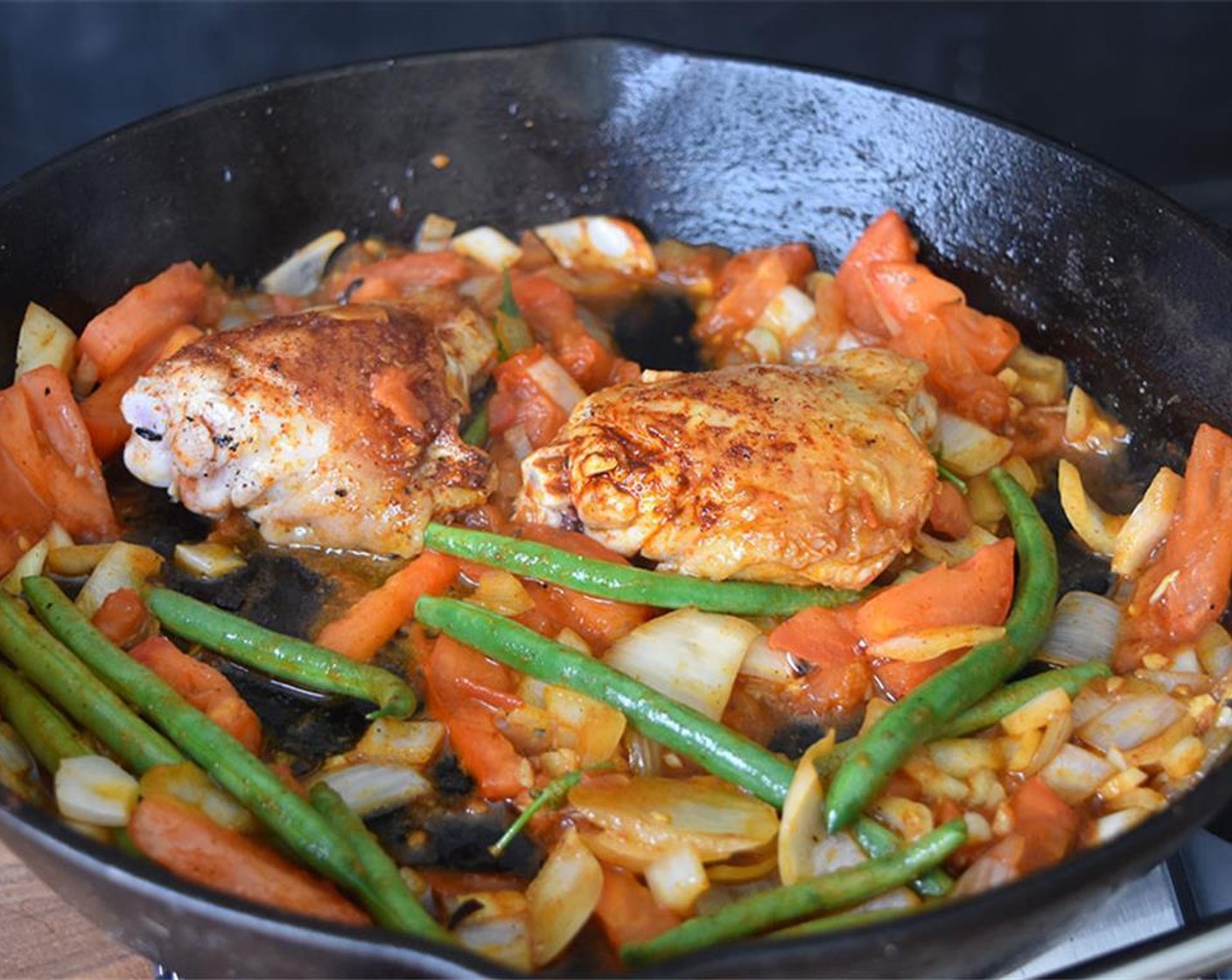 step 3 Add Green Beans (2 cups), Garlic (3 cloves), Paprika (1 Tbsp), Tomatoes (3), Salt (to taste), and Ground Black Pepper (to taste). Stir occasionally as flavors begin to meld.