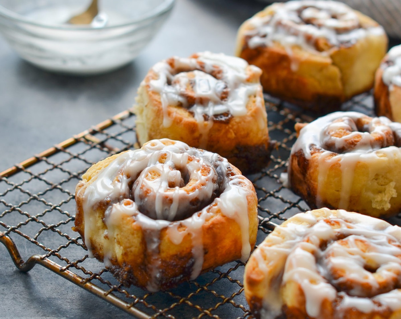 step 15 Drizzle the glaze evenly over the buns. Serve warm out of the oven, or store in airtight container and reheat.