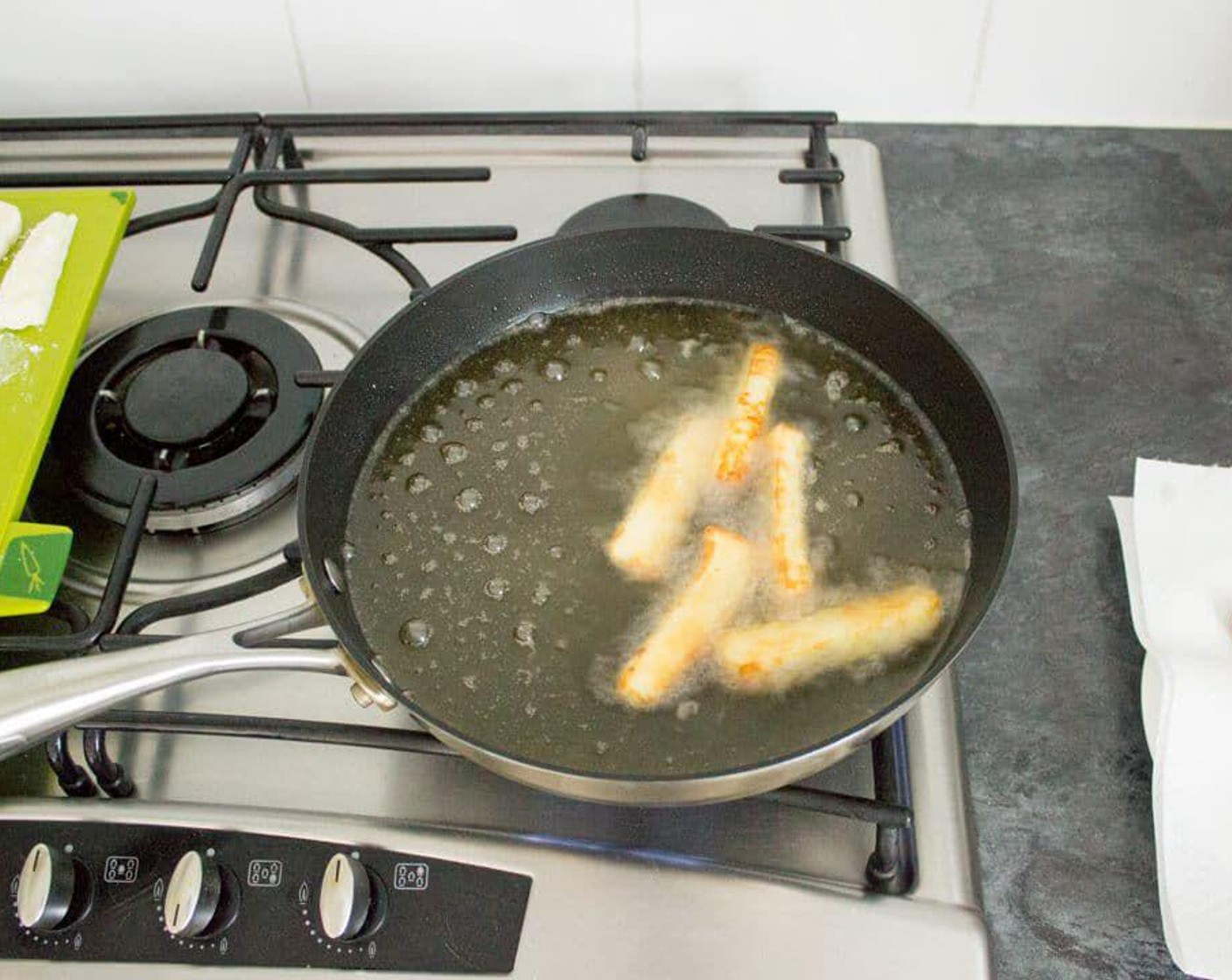 step 4 Now check if the oil is hot enough by dipping the end of one of the fries in. It should start to sizzle. If it does, add 5 or 6 into the pan and cook for about 5 minutes until golden all over. Turn them over occasionally if you need to.