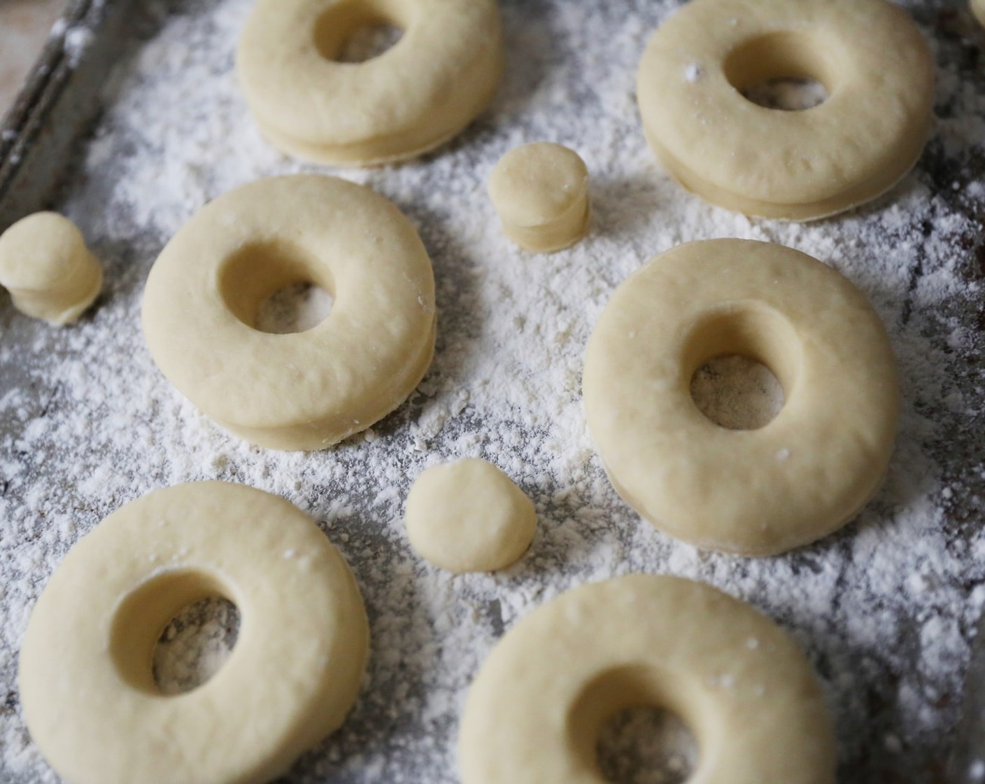 step 13 Place doughnuts on a floured baking sheet, with a few inched between them. Cover with a clean tea towel and place in a warm place to double in size, around 30 minutes.