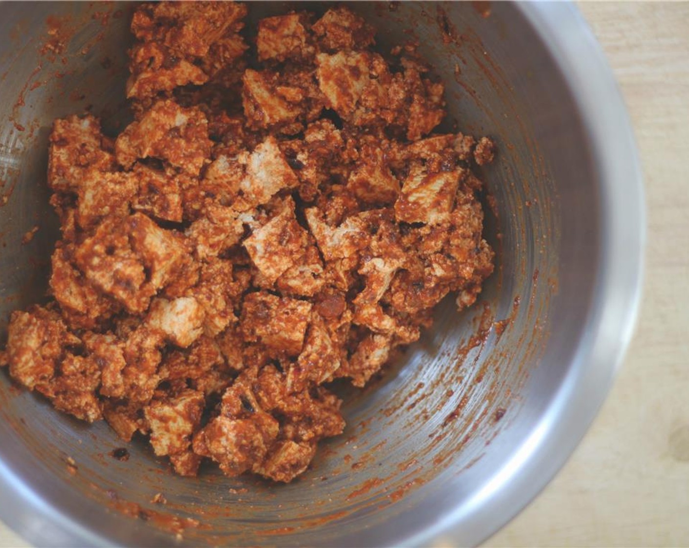 step 4 Crumble the tofu in a large bowl and coat with about 2/3 of the hot sauce you just made. Let sit for about 15 minutes.