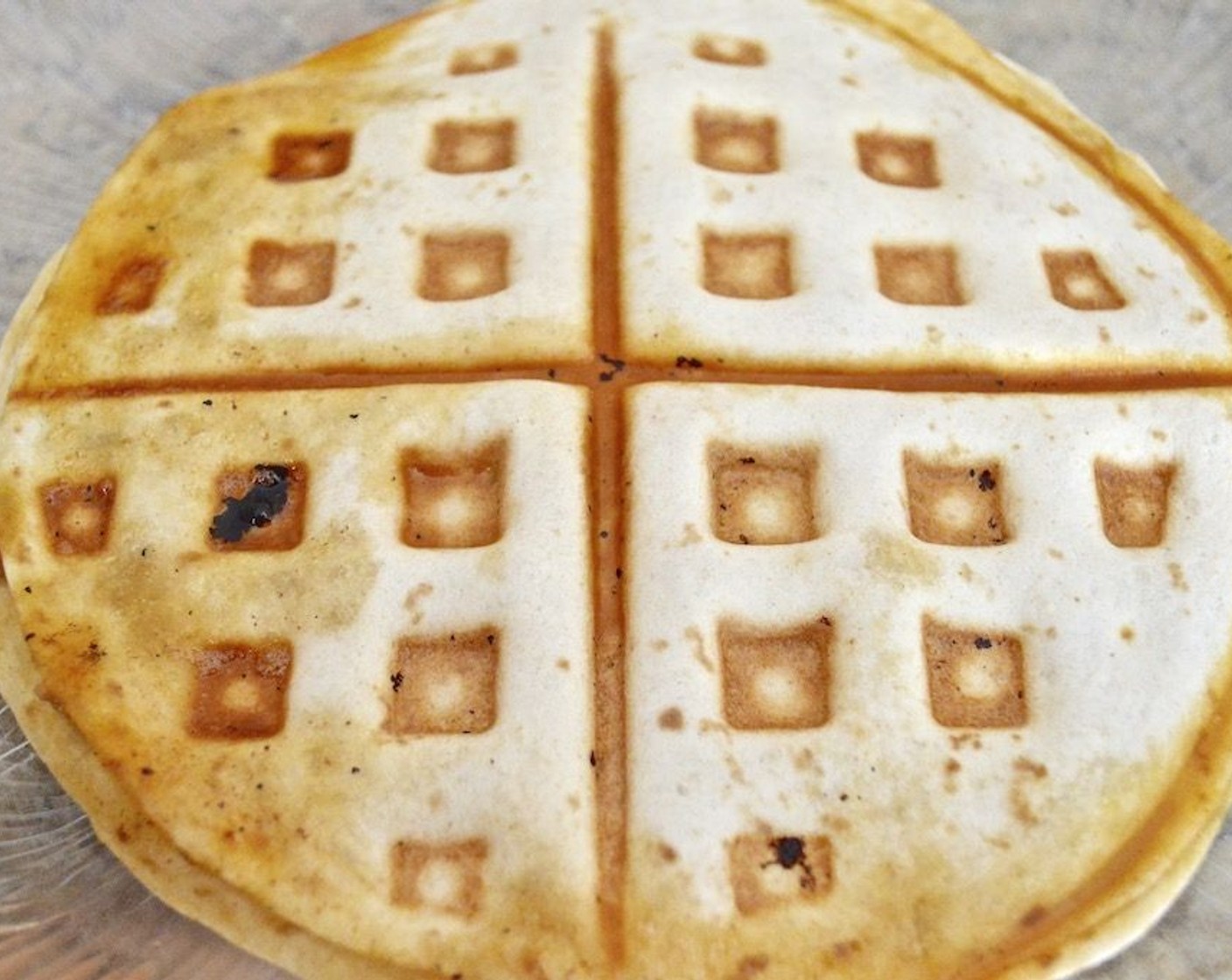 step 6 Close it up with another tortilla, and then grease the preheated waffle maker with Nonstick Cooking Spray (as needed). Close the quesadilla in the waffle maker to cook for 5 minutes. It should get really golden on the outside and melty in the middle.