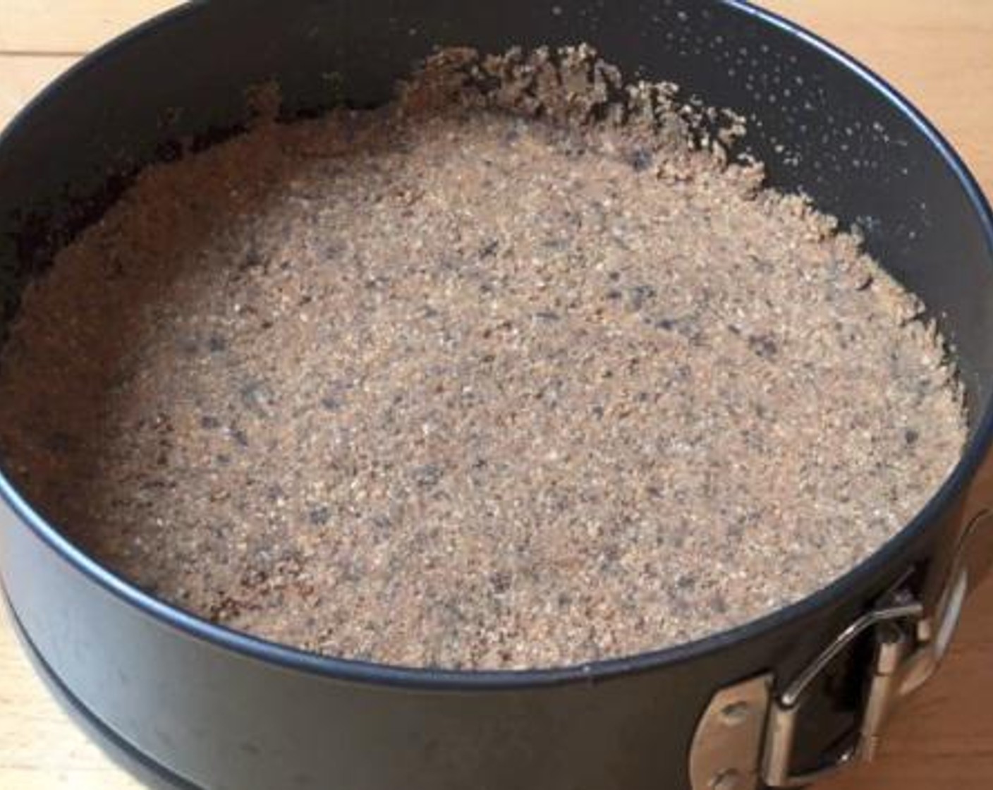 step 1 Into a mixing bowl, mix together the Graham Crackers (2 1/3 cups), Unsweetened Cocoa Powder (1/2 Tbsp), and Butter (1/3 cup). Transfer the mixture into a greased tin, and use the bottom of a glass to press down the crumbs. Then, put the tin in the fridge for about 20 minutes.