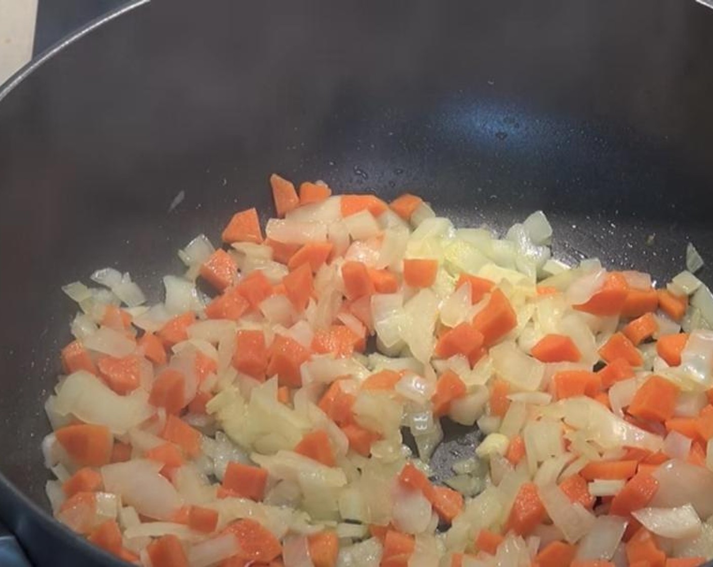 step 1 Add Olive Oil (as needed) to a pan over medium-high heat. Once hot, add Yellow Onion (1) and Carrot (1). Cook and occasionally stir for 5 to 10 minutes or until vegetables have softened.