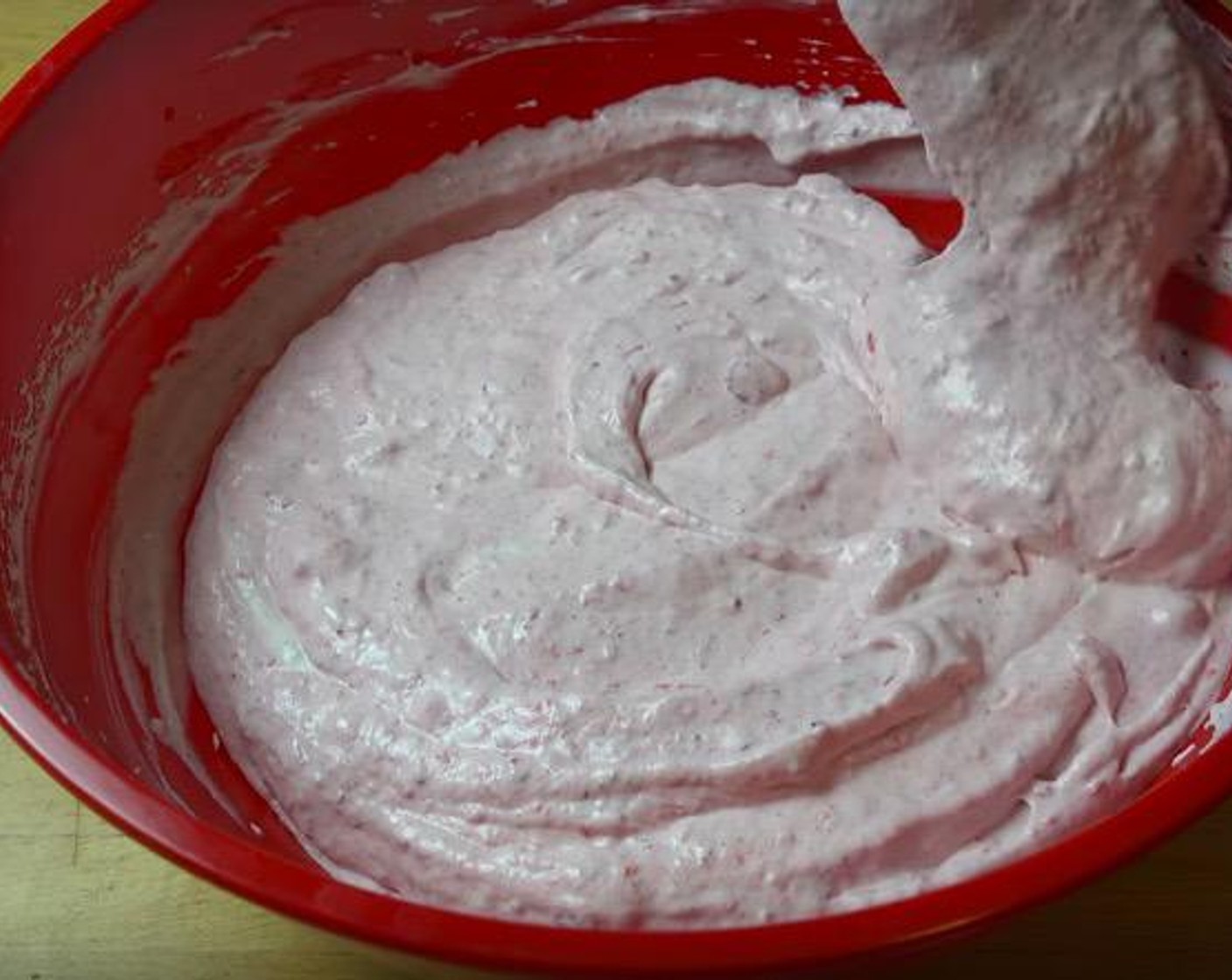 step 3 Pour in the strawberry puree and carefully fold it into the cream mixture.