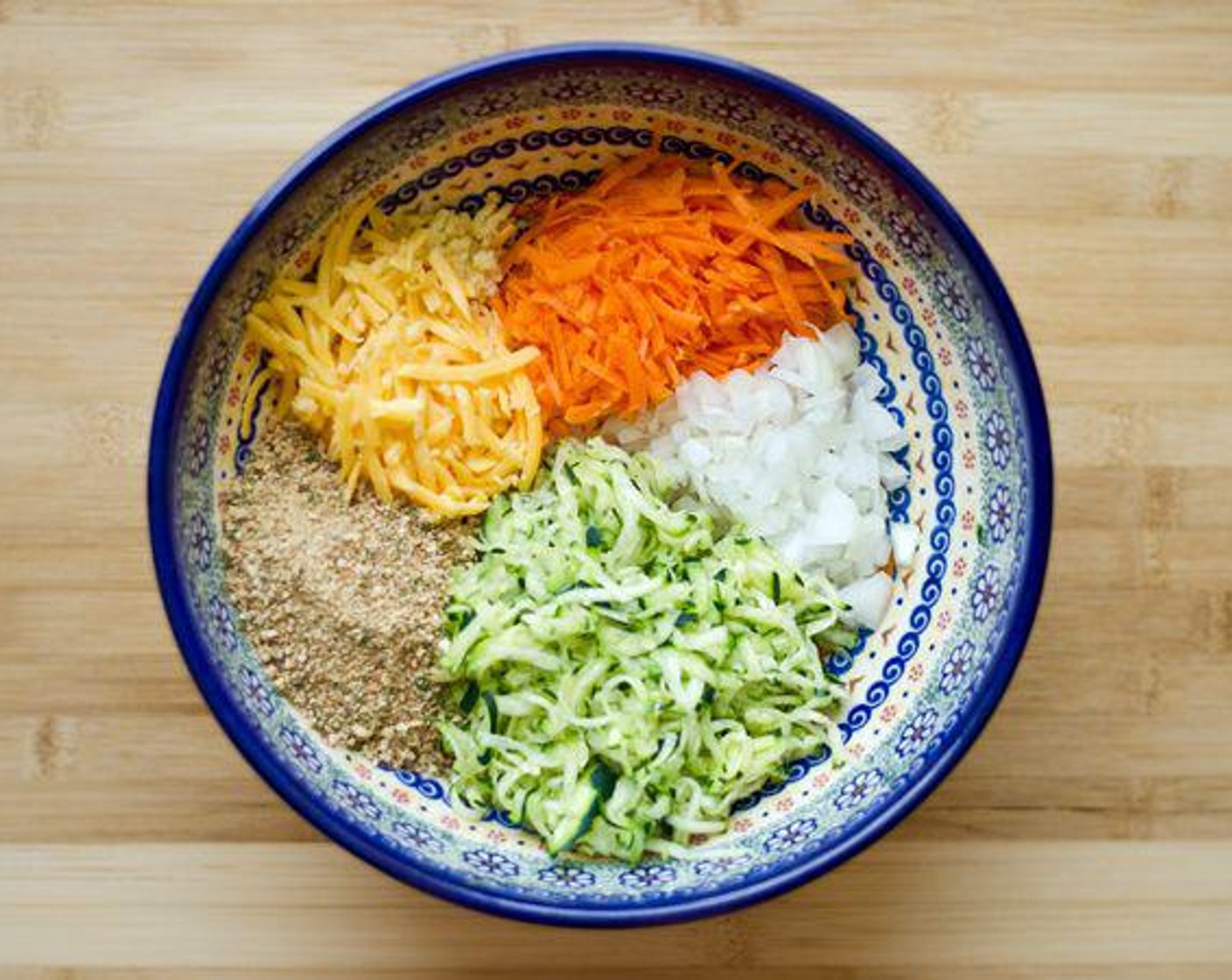 step 2 Mix Sharp Cheddar Cheese (1/2 cup), Whole Wheat Panko Breadcrumbs (4 Tbsp), White Onion (1/2 cup), Carrot (1/2 cup), Eggland's Best Classic Egg (1), and Garlic (1 clove) in large bowl.