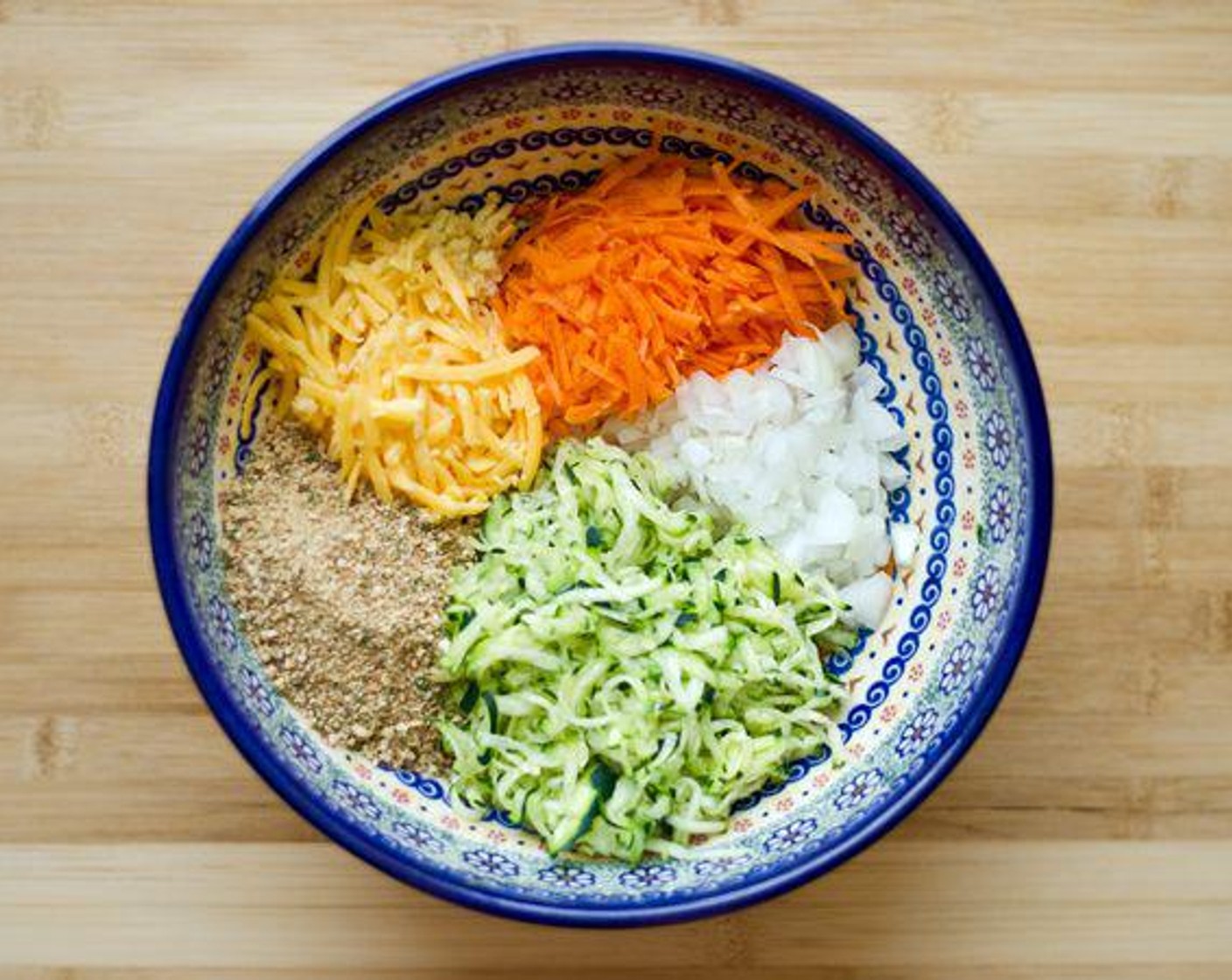 step 2 Mix Sharp Cheddar Cheese (1/2 cup), Whole Wheat Panko Breadcrumbs (1/4 cup), White Onion (1/2 cup), Carrot (1/2 cup), Egg (1), and Garlic (1 clove) in large bowl.