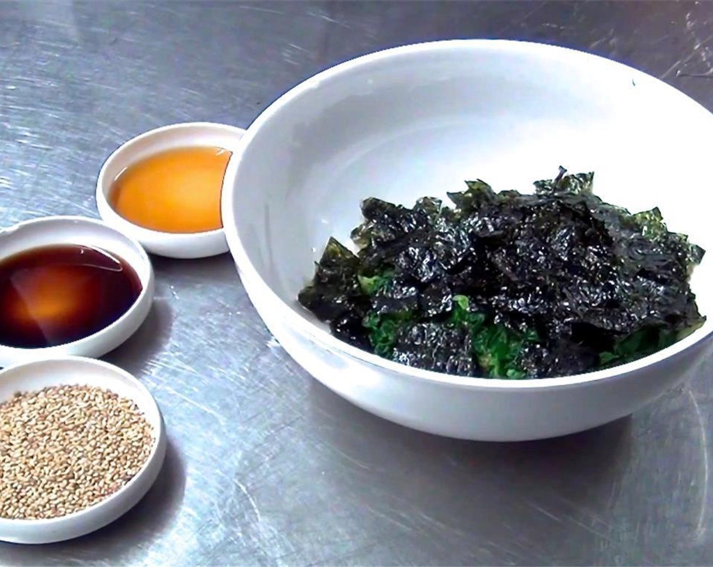 step 5 Add Soy Sauce (1 Tbsp), Sesame Seeds (1 Tbsp) and Sesame Oil (1 Tbsp) to the spinach, and mix well.