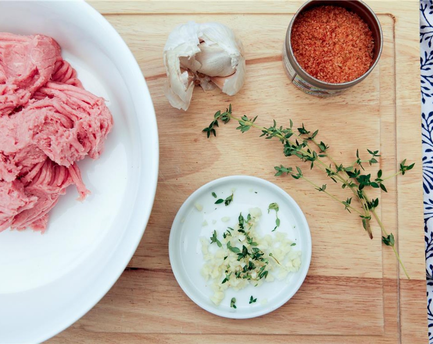 step 5 While the zucchini bakes, begin preparing the turkey burgers. Pull the leaves off of the Fresh Thyme (1 sprig) and finely chop. Mince the Garlic (2 cloves).