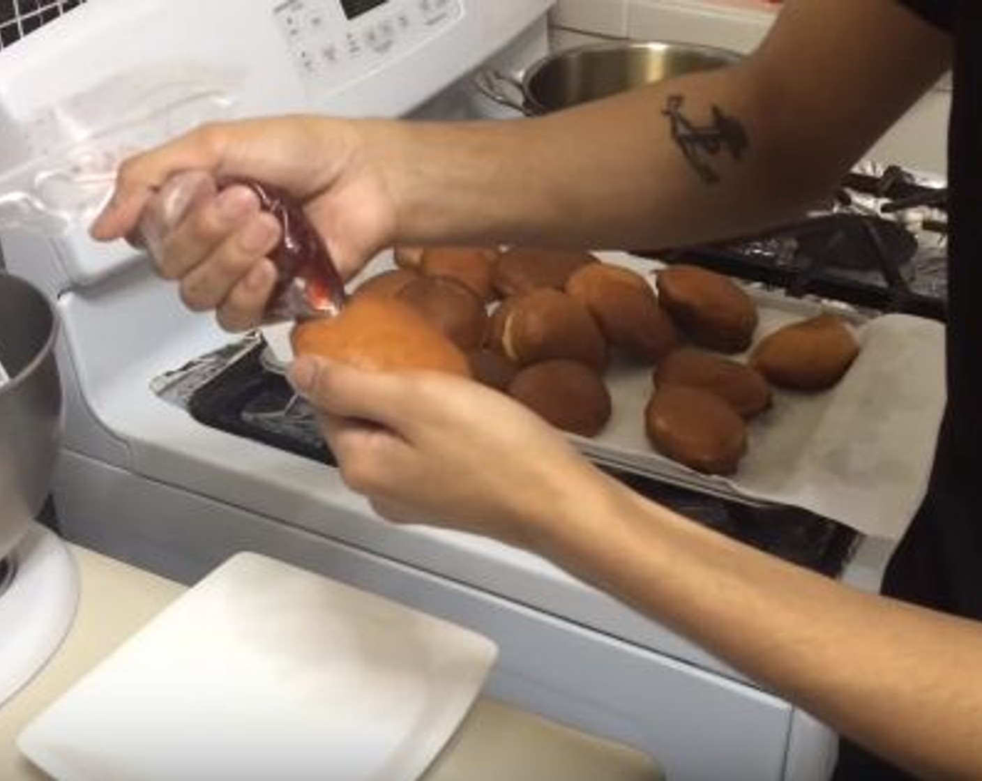 step 8 With a knife or a popsicle stick,  make a hole to the middle of the doughnut. Pipe in the Strawberry Jelly (1/2 cup). Roll the doughnuts in Granulated Sugar (1/2 cup).