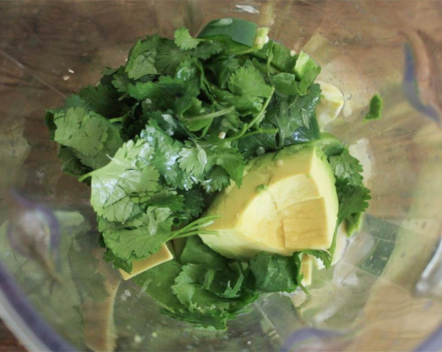 step 5 Add the tomatillos, Avocado (1), Garlic (2 cloves), Jalapeño Pepper (1) along with the Fresh Cilantro (1/4 cup) into a food processor. Juice one Lime (1) into the food processor, add a pinch of Salt (1 pinch) and Extra-Virgin Olive Oil (1 Tbsp).