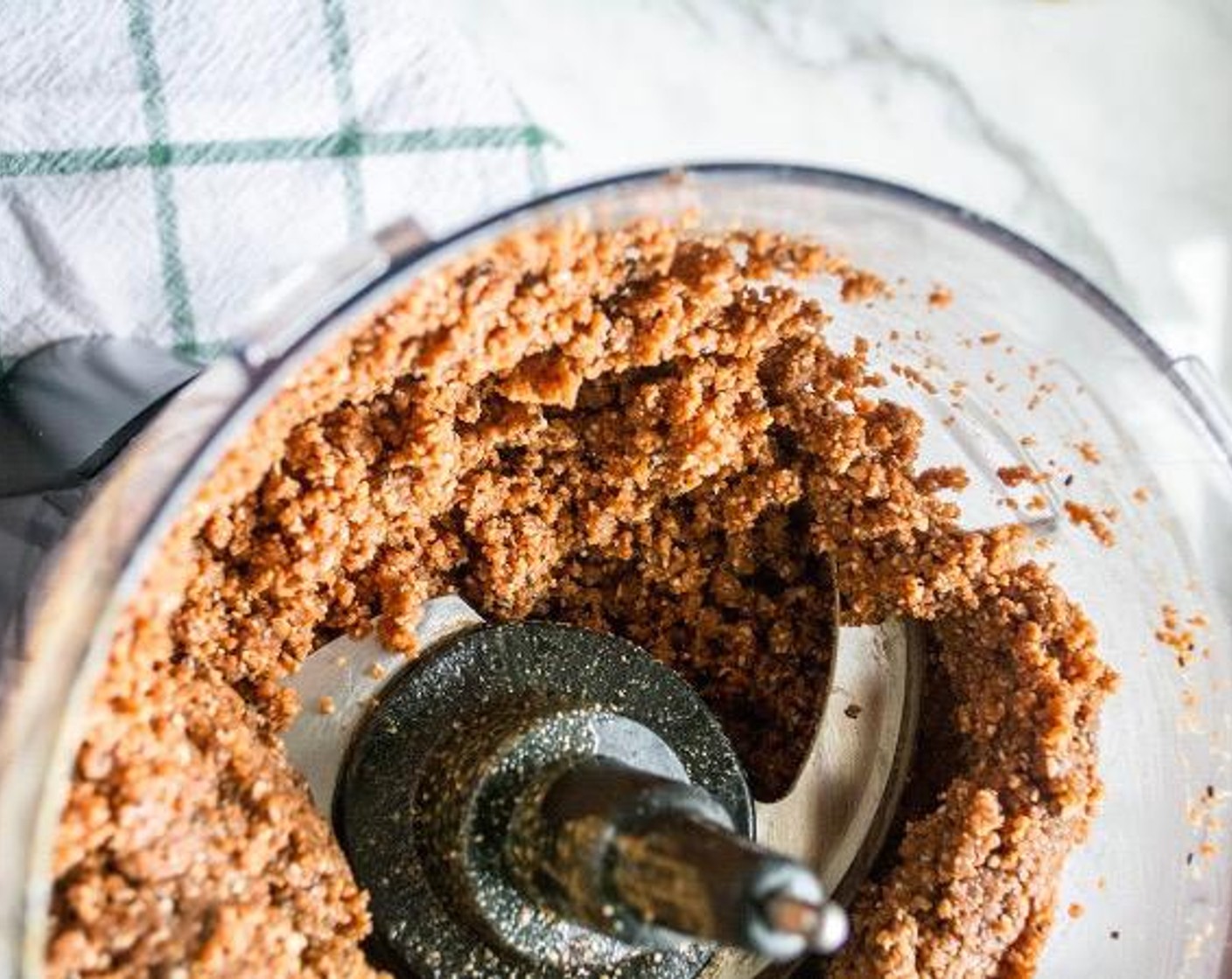 step 3 Add in melted dark chocolate, Peanut Butter (3/4 cup), Chia Seeds (2 Tbsp), Vanilla Extract (1/2 Tbsp) and Sea Salt (1 tsp). Blend another 45-60 seconds. The texture will look crumbly but should be able to be packed together.