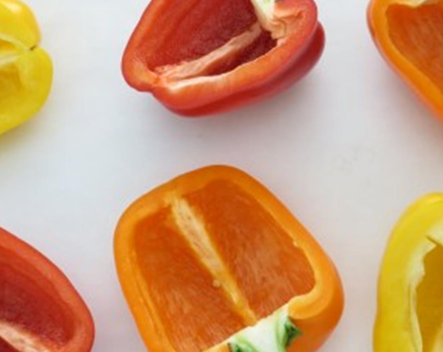 step 5 Line a large, rimmed baking sheet with parchment paper or aluminum foil. Place the sliced vertically through the stem with seeds and ribs removed Bell Peppers (3), cut side up onto the baking sheet.