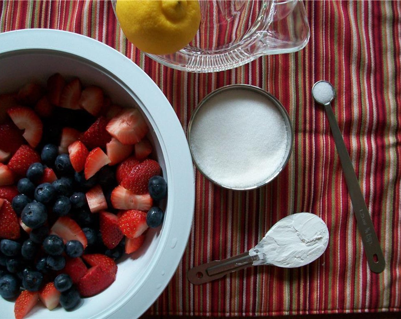 step 3 Put the Frozen Mixed Berries (3 cups) in a large bowl and coat with Corn Starch (1 Tbsp), a third of the Salt (1/4 tsp), white Granulated Sugar (1/2 cup) and juice from Lemon (1).