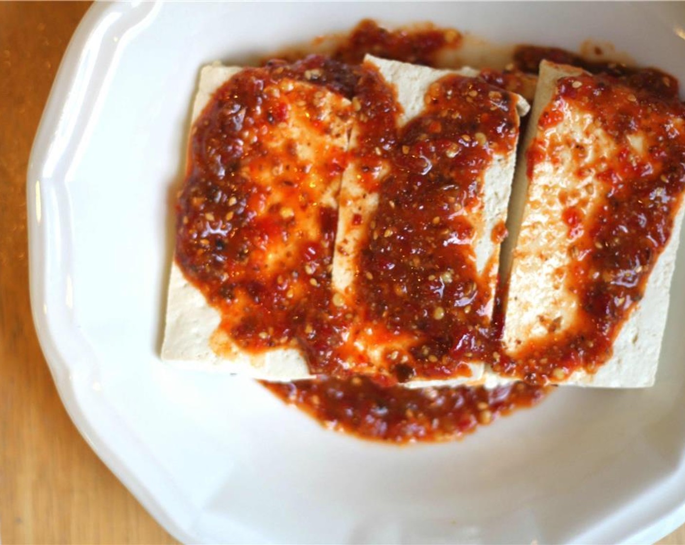 step 8 When the tofu is as dry as possible, coat the slabs in all the marinade, but don't rinse out the bowl. Heat a grill or frying pan on the stove for the tofu on high heat.