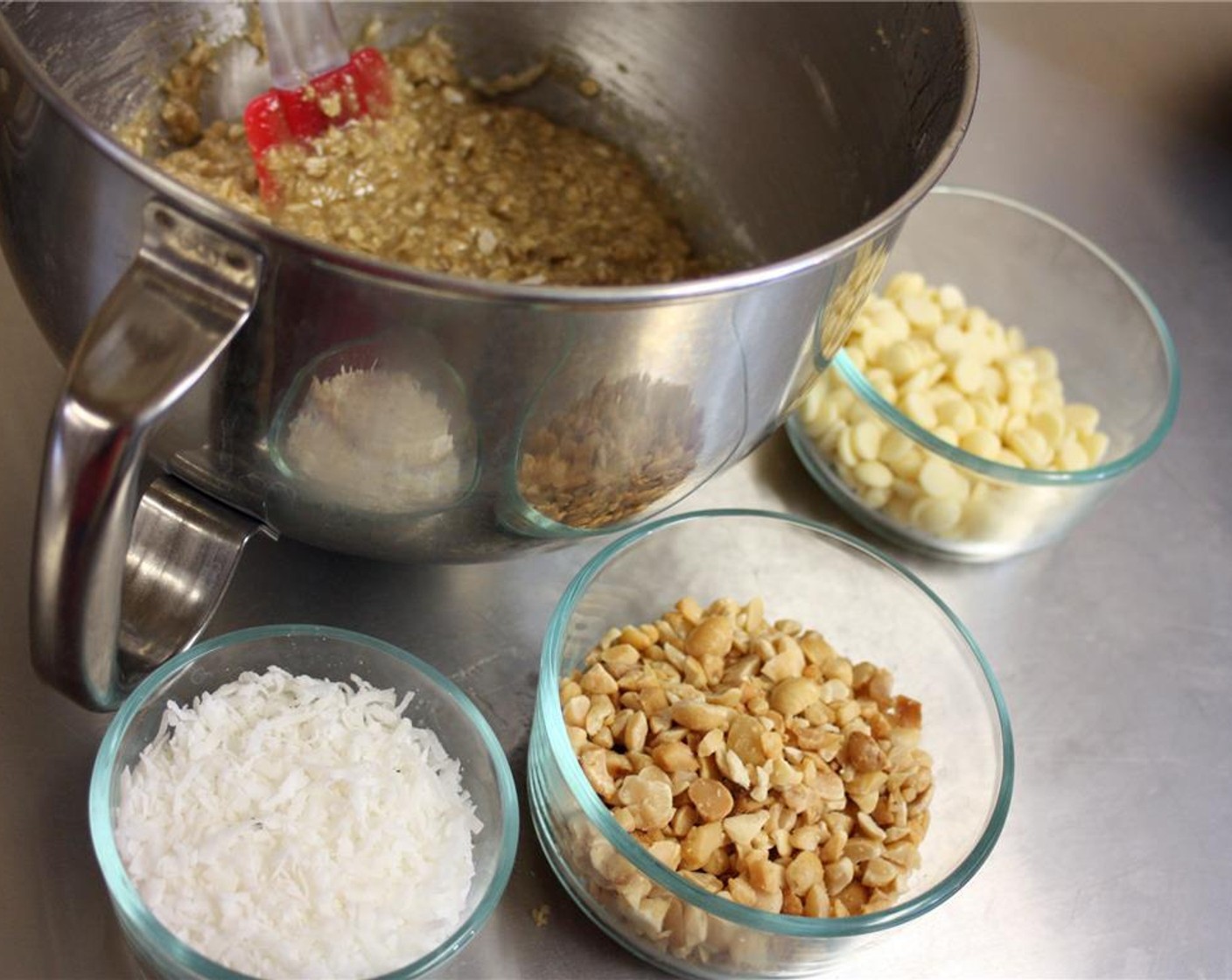 step 6 Add flour mixture to the wet in two batches and mix by hand using a rubber spatula. Fold in Vegan White Chocolate Chips (3/4 cup), Macadamia Nuts and Sweetened Coconut Flakes (3/4 cup). Mix all the ingredients well.