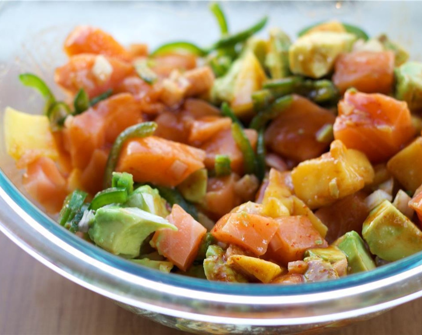 step 4 Add the Mango (1), Avocado (1),Shallot (1 Tbsp), and Jalapeño Pepper (1) to the bowl with the salmon. Gently stir to combine.