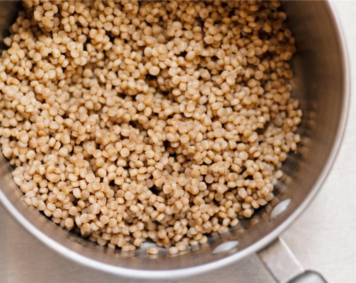 step 1 Prepare the Whole Wheat Israeli Couscous (1 cup) according to the package instructions: bring Water (1 1/2 cups) and Salt (1/2 tsp) to a boil in a medium sauce pot. Add the couscous. Cover and reduce the heat to low, simmering for 10 minutes or until water is absorbed.