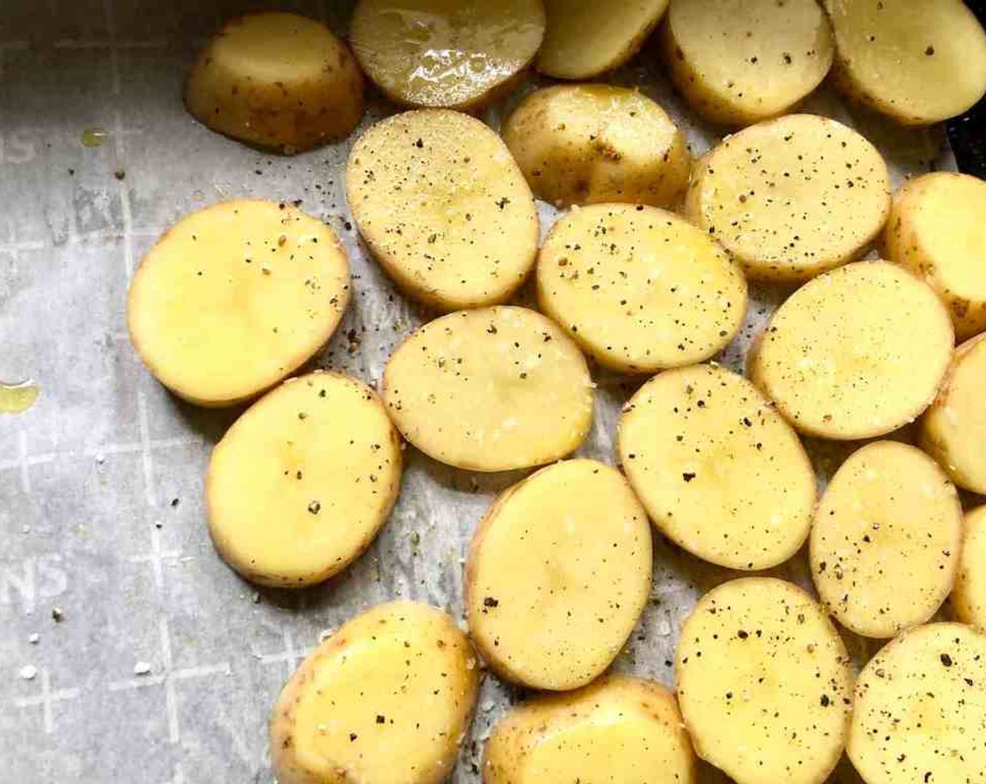 step 4 Grease a 15x10x1-inch baking pan or line with parchment paper. Brush the Yukon Gold Potatoes (3 cups) lightly with Olive Oil (1 Tbsp). Season with Salt (to taste) and Freshly Ground Black Pepper (to taste).