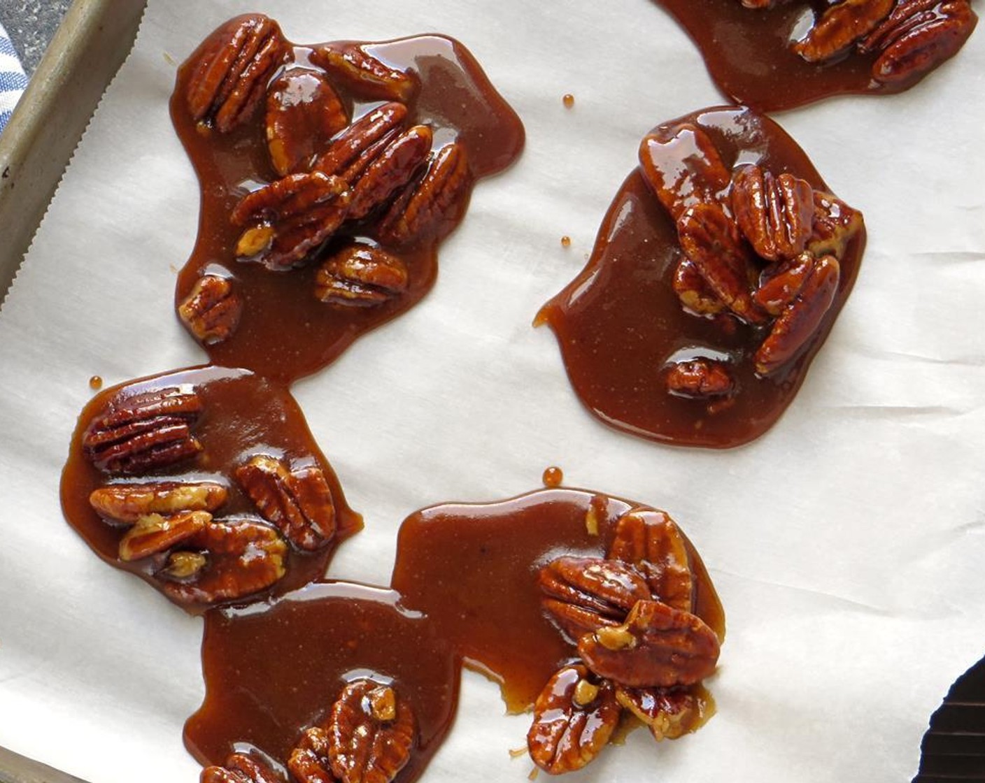 step 3 Drop pecan mixture by spoonfuls onto parchment paper - so that they form little rounds of pecan and melted sugar that spread out on the paper.