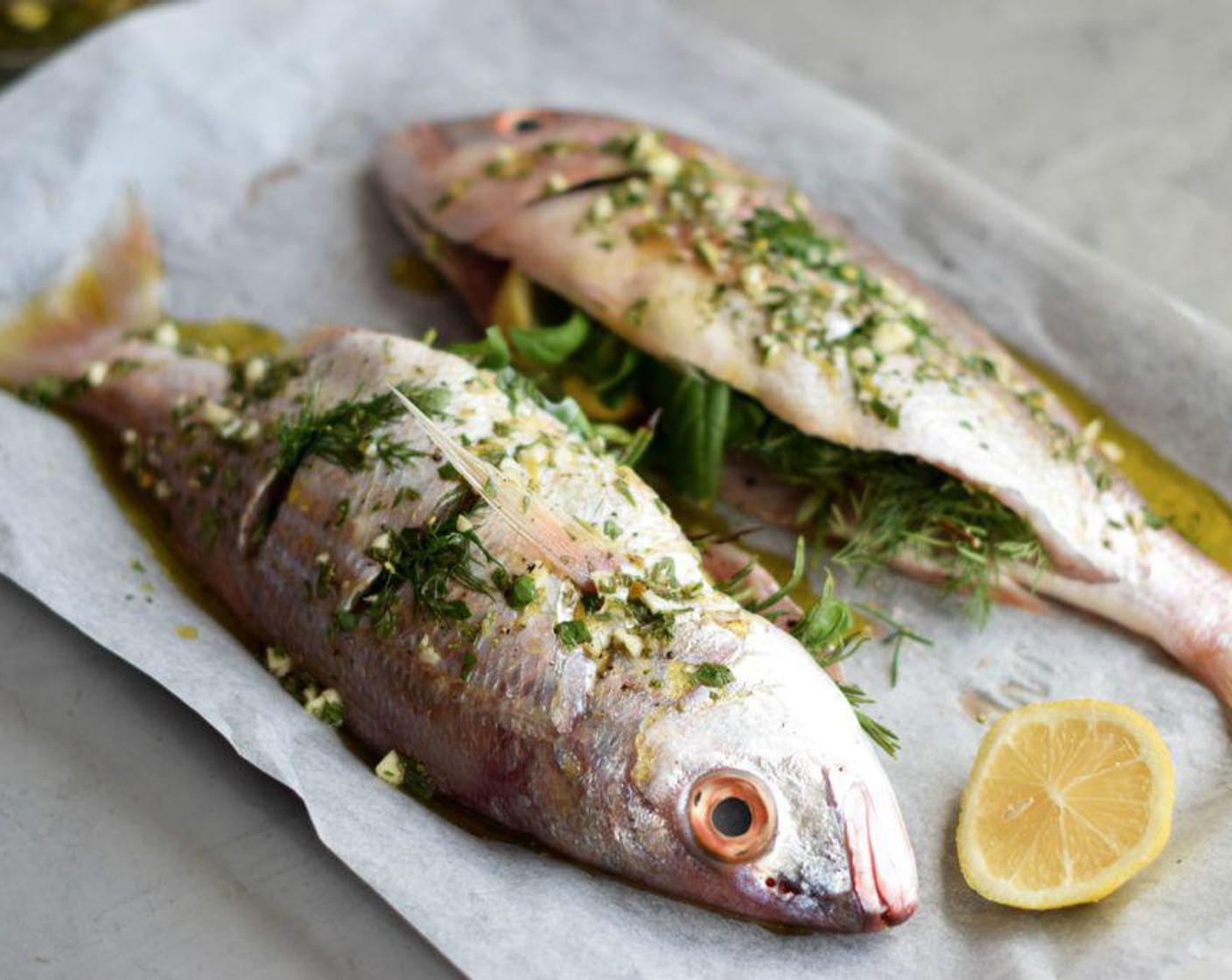 step 5 Roast the fish at 180 degrees C (350 degrees F) for 20 to 24 minutes until the flesh is no longer translucent and it pulls away easily from the skin. Remove the herb bouquets and serve the silvers immediately with a simple green salad and a loaf of crusty bread.