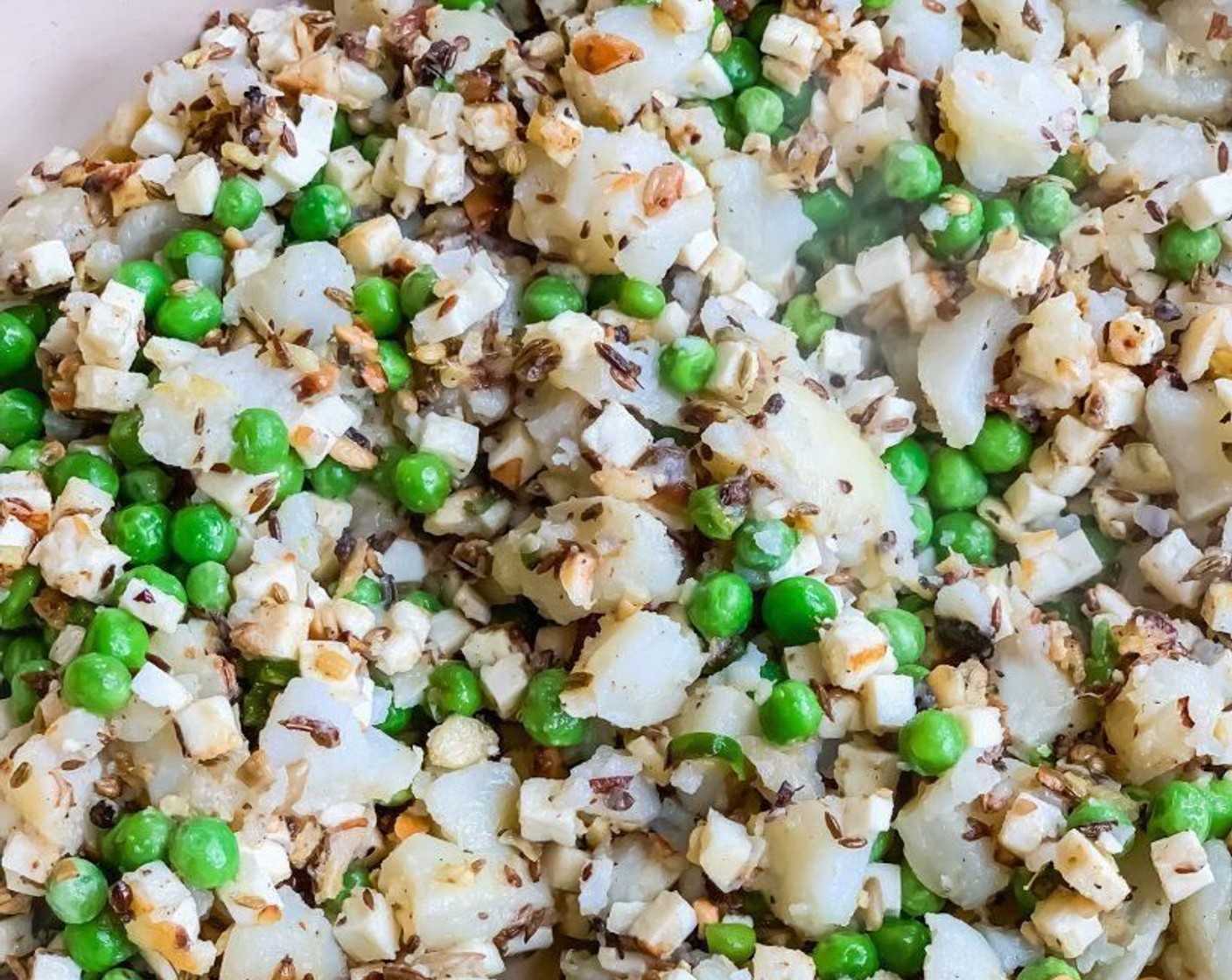 step 9 Add the Potato (1 cup), Paneer (1 cup) and Frozen Green Peas (1/2 cup) to the pan. Mix everything together.