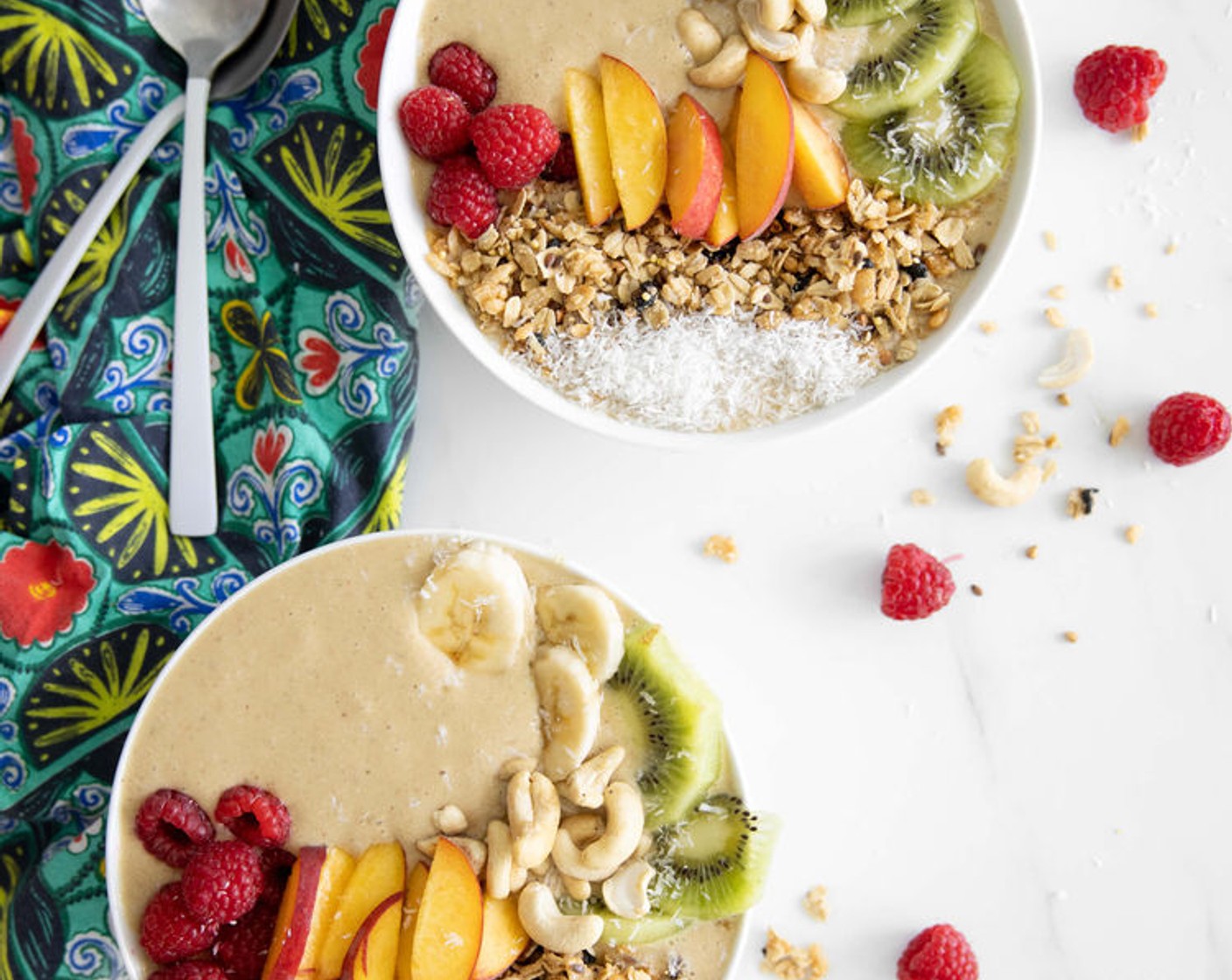 step 3 Pour smoothie mixture into 2 bowls and top with Unsweetened Shredded Coconut (to taste), Kiwifruit (to taste), Peaches (to taste), Cashew Nuts (1 handful), Bananas (to taste), and Granola (to taste).