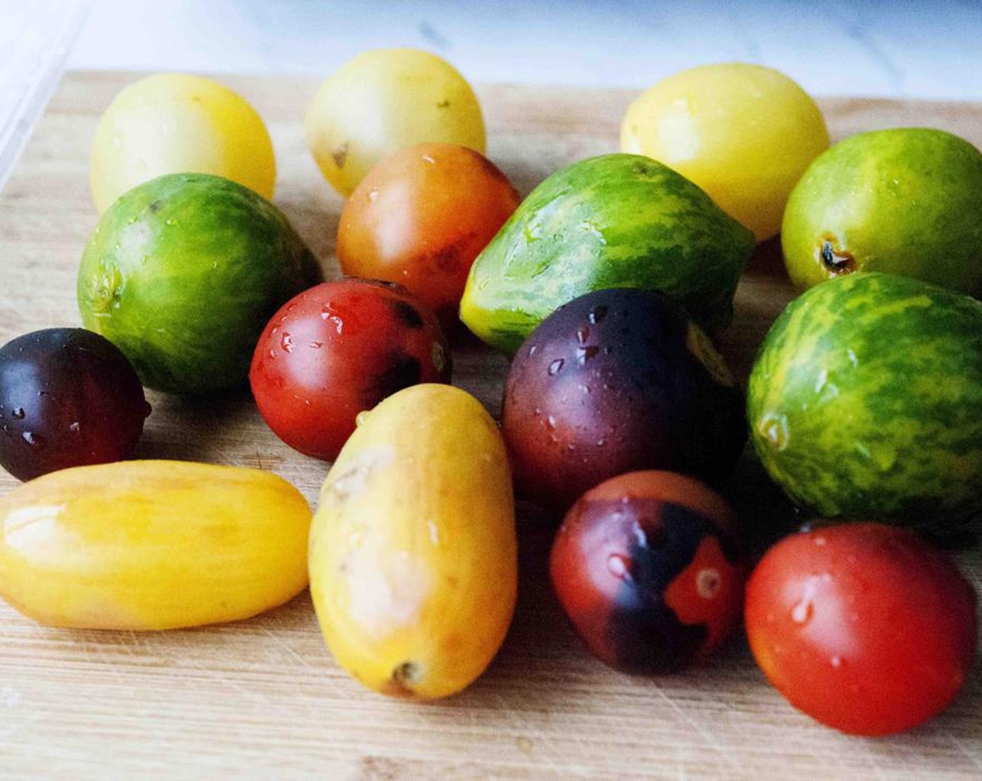 step 5 Wash your Heirloom Tomatoes (2 3/4 cups), cut them in half and place them on the baking tray next to your fish.