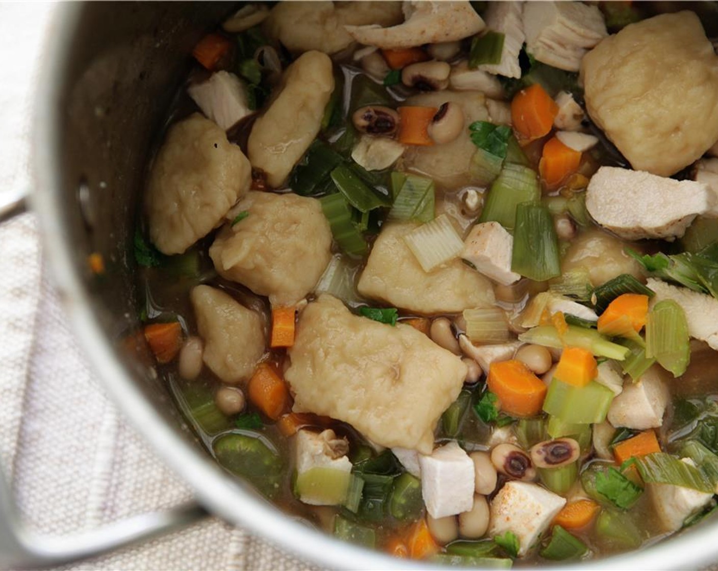 step 11 Cook the dumplings for 10-15 min, gently stirring every 5 minutes. Once the dumplings are cooked through and tender add the chicken, parsley and cut veggies. Remove from the heat and add the Sour Cream (3 2/3 Tbsp).