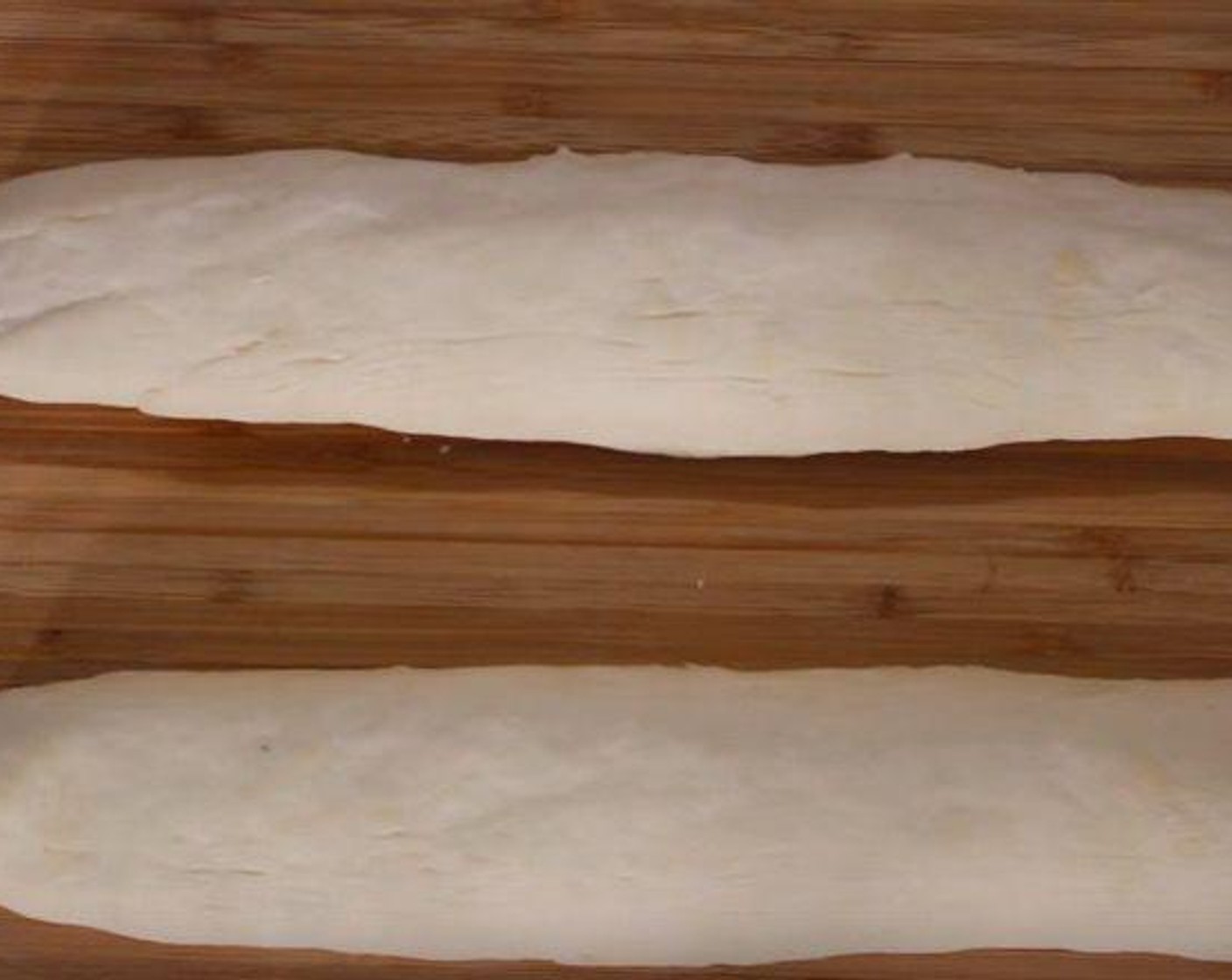 step 6 Turn the dough out onto a clean surface and divide it into 2 pieces. Roll each piece into a 12-inch long loaf.
