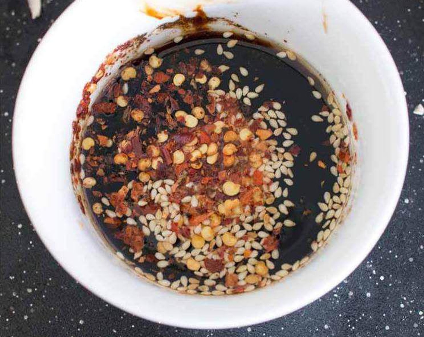 step 2 Mix the Dark Soy Sauce (1 tsp), Light Soy Sauce (2 Tbsp), Sesame Oil (1 tsp), Sesame Seeds (1 pinch), and Crushed Red Pepper Flakes (1 pinch) in a small bowl. Set aside.