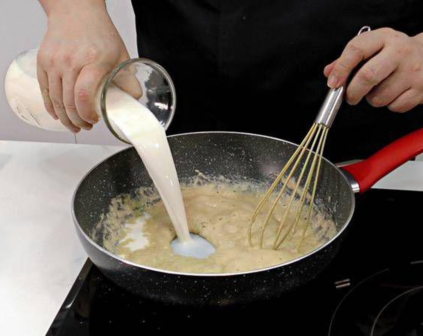 step 4 At this point we can add in the Milk (4 cups) and start mixing with a whisk continuosly. The most important thing is that no lumps form.