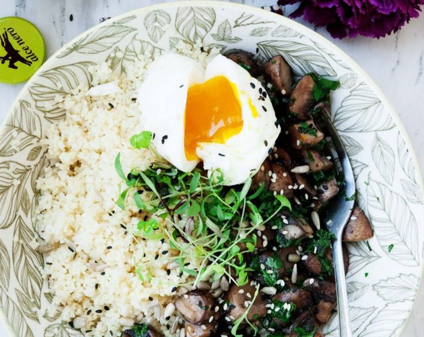 step 8 Divide the couscous into 2 medium size bows, top it off with the sautéed mushrooms, one poached egg and some Alfalfa Sprouts (to taste) Sprinkle with some Black and White Sesame Seeds (to taste) if you fancy!