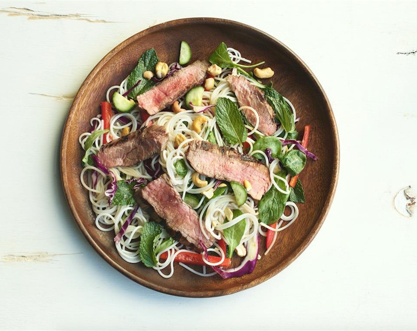 step 10 In the center of two plates place the salad mixture. Top with steak slices and garnish with Cashew Nuts (2 Tbsp). Serve and enjoy!